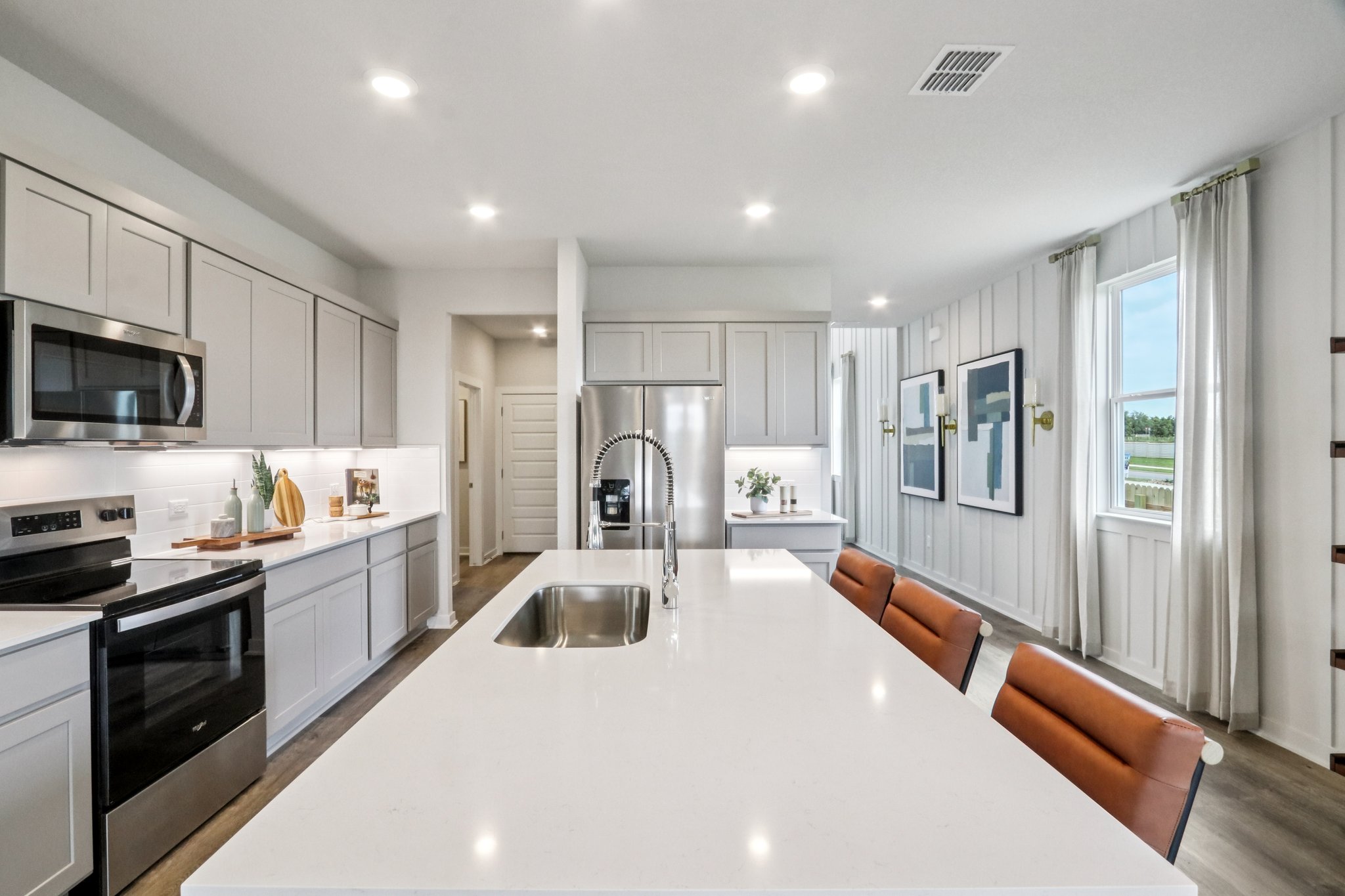 A kitchen with white cabinets.