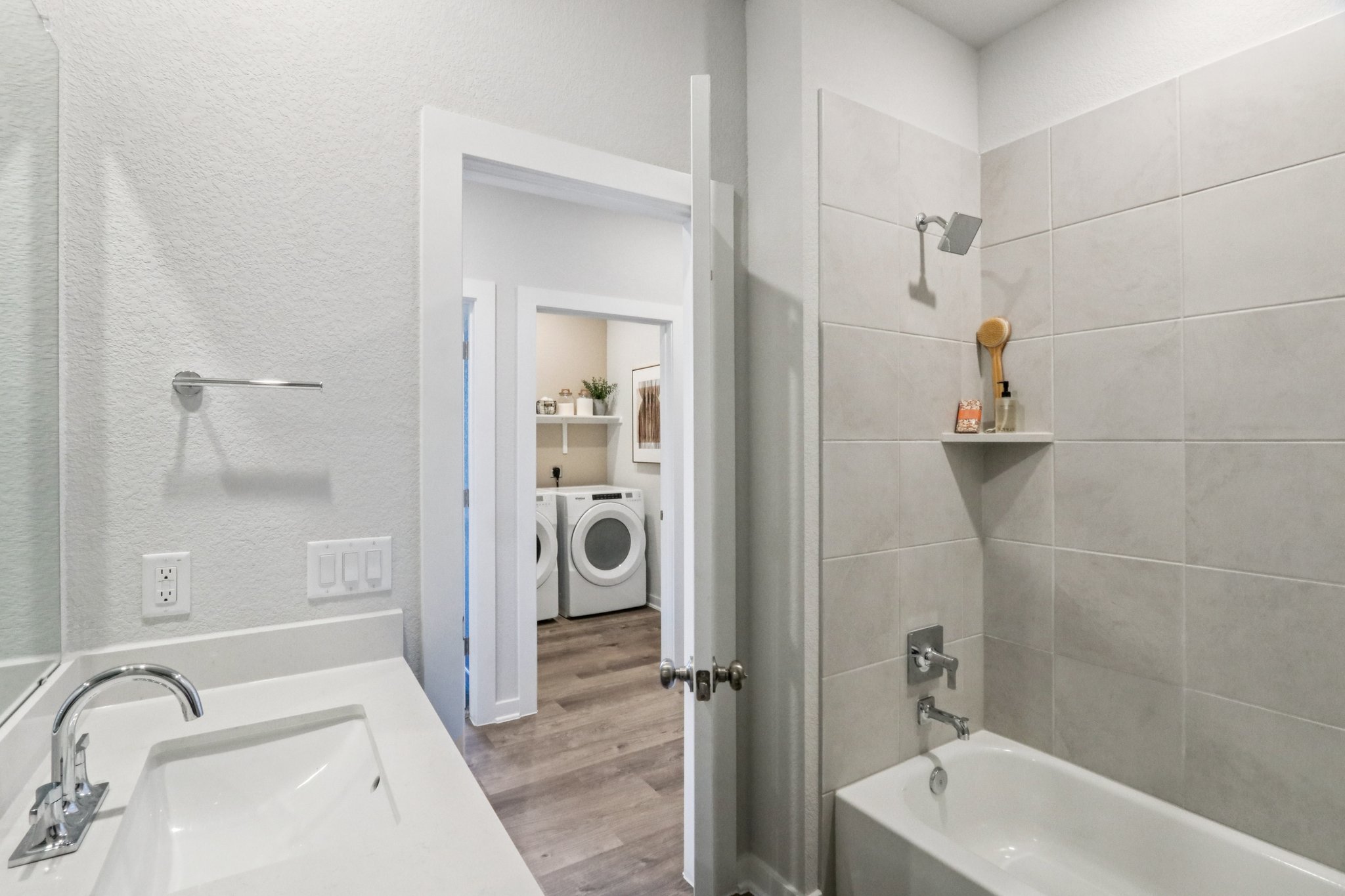 A bathroom with a sink and a bathtub.