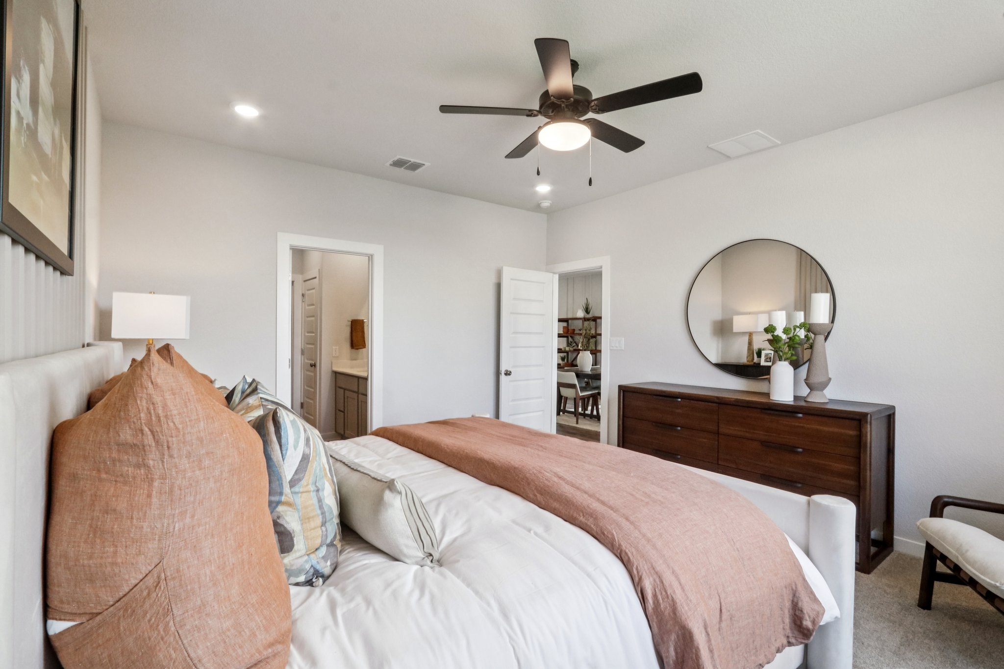 A bedroom with a bed and a fan.