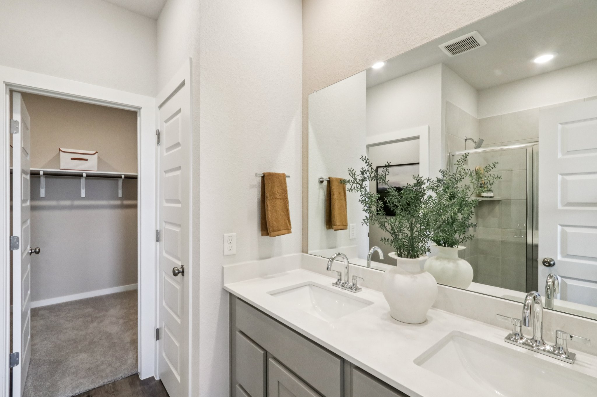 A bathroom with a large mirror.