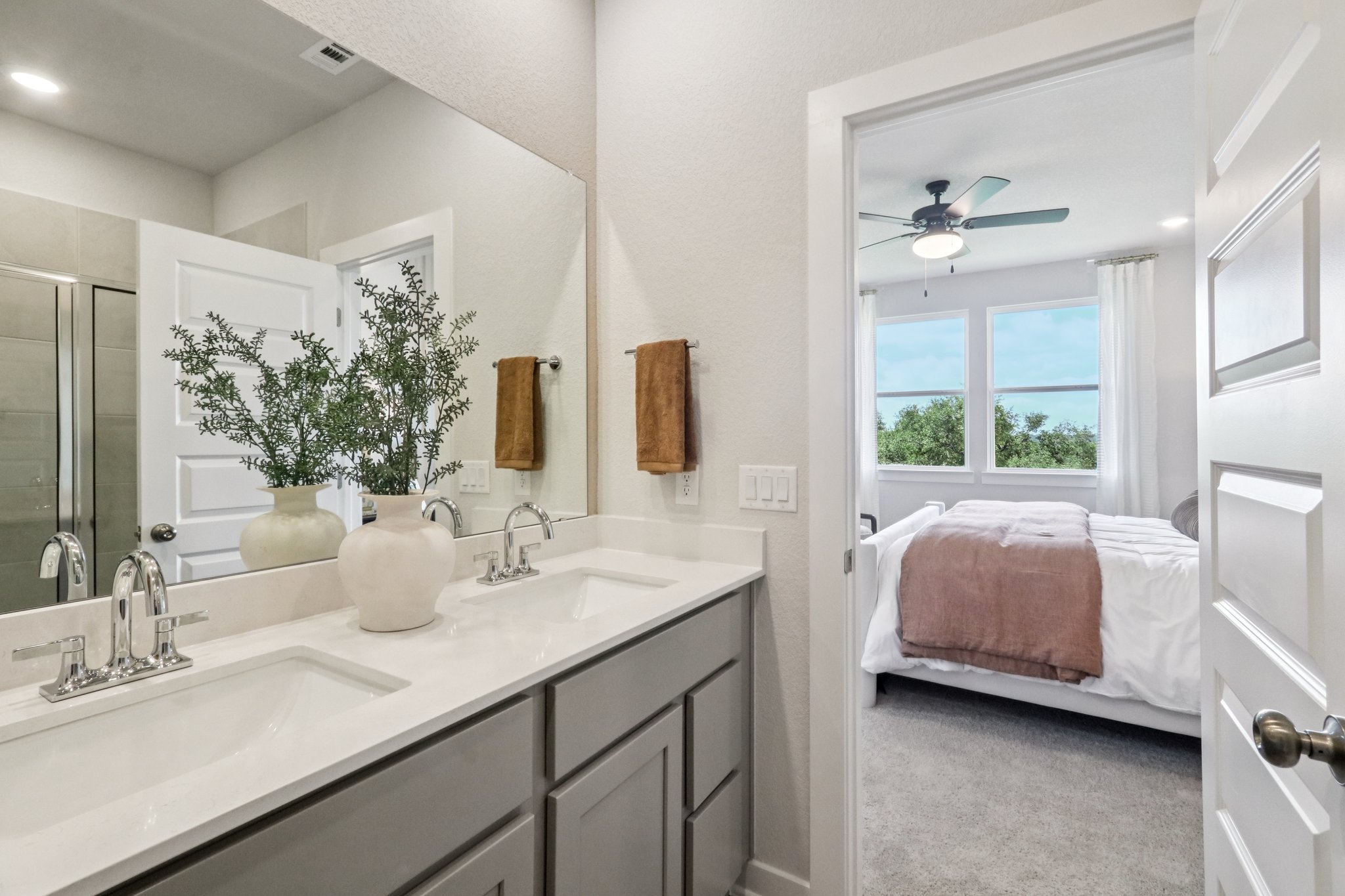 A bathroom with a large mirror.