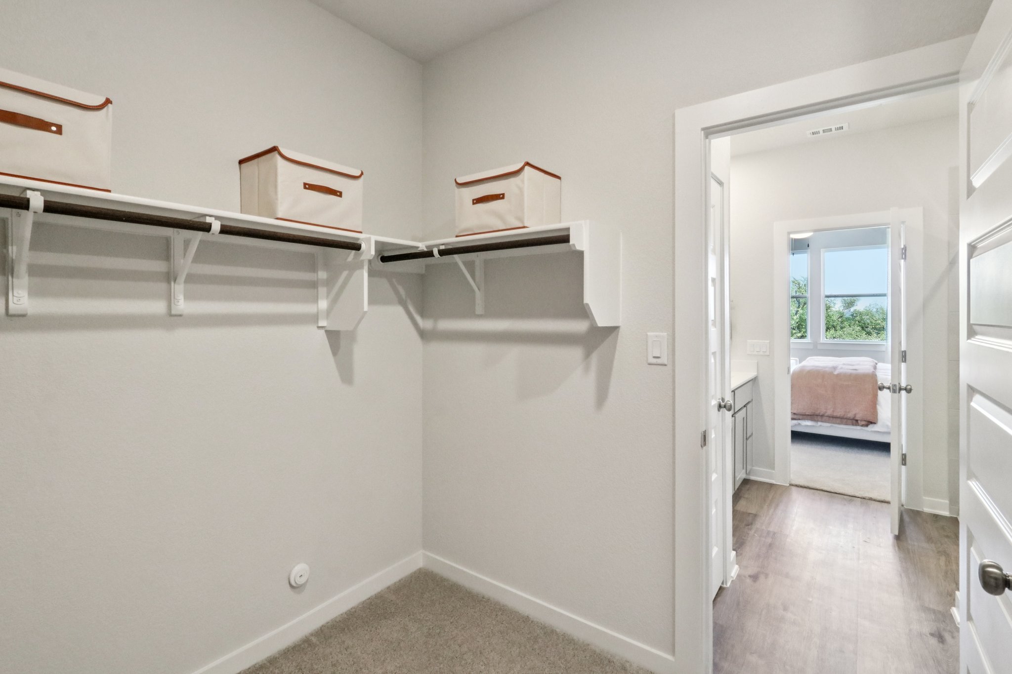 A room with a bed and a shelf.