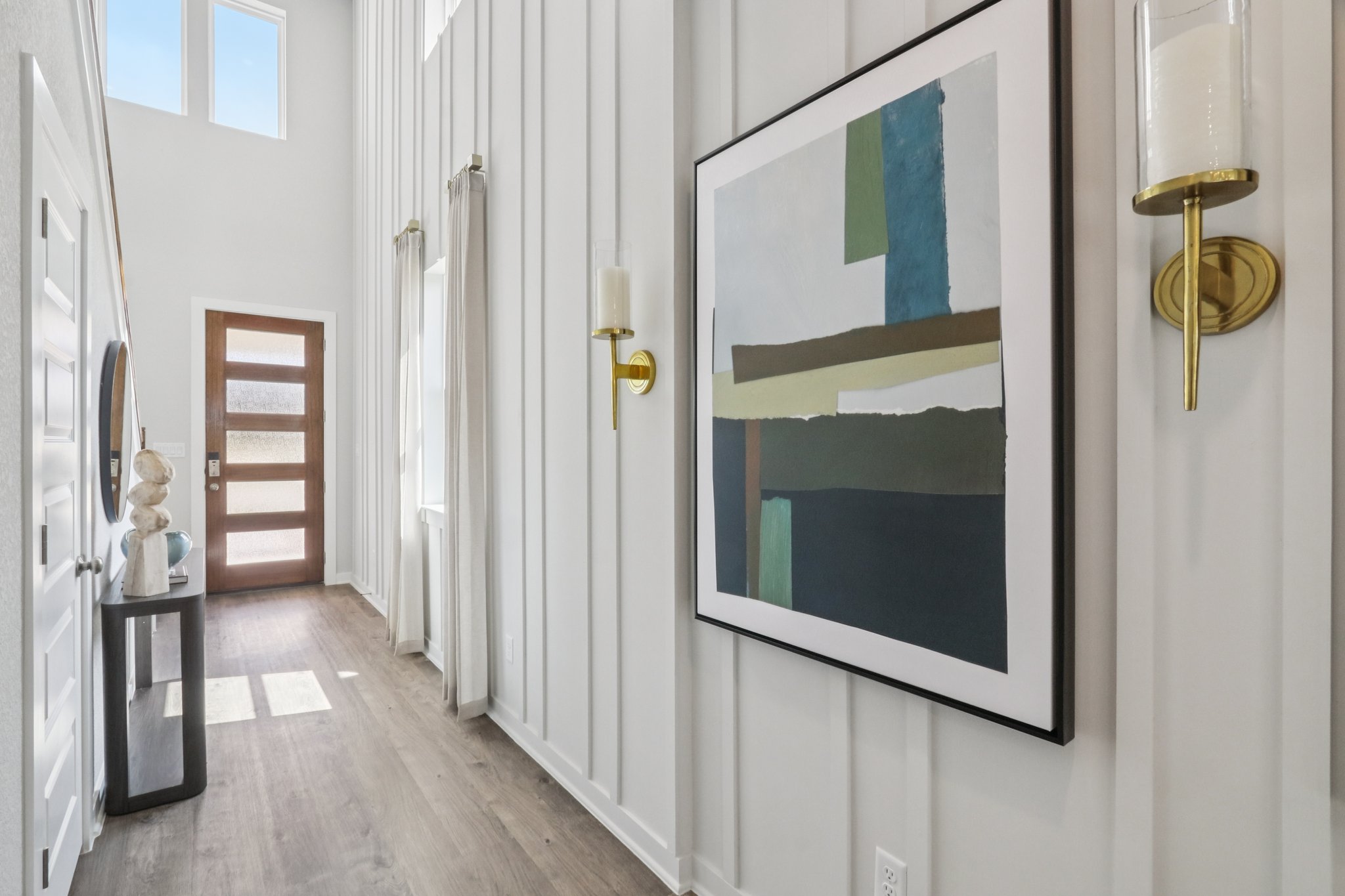 A hallway with a door open.