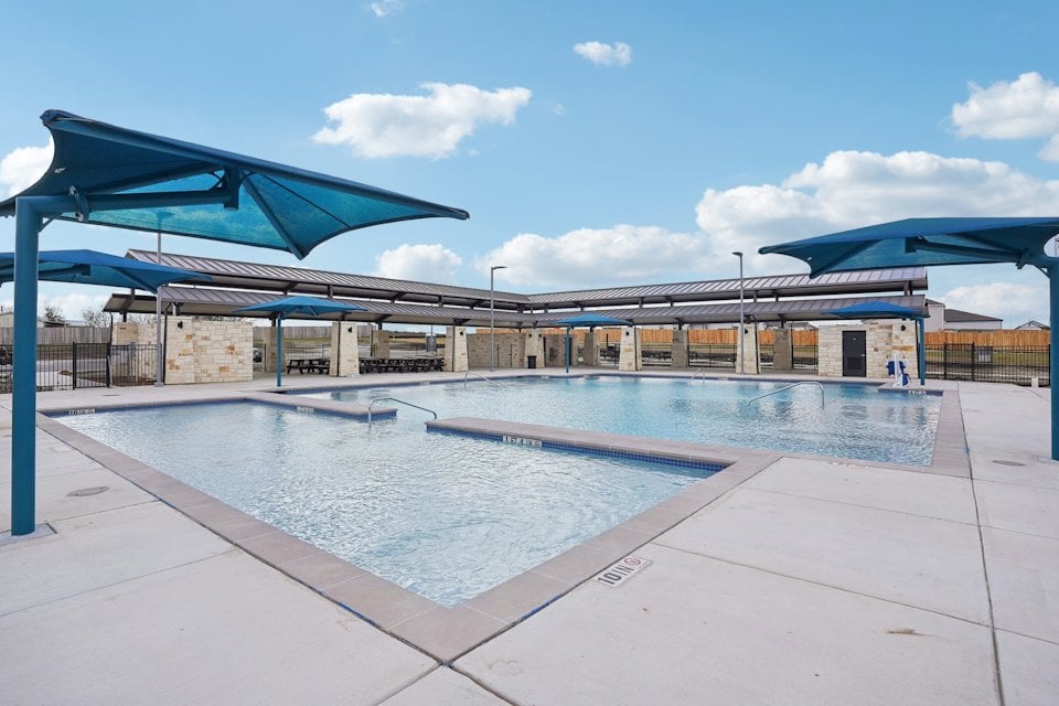 A swimming pool outside of a building.
