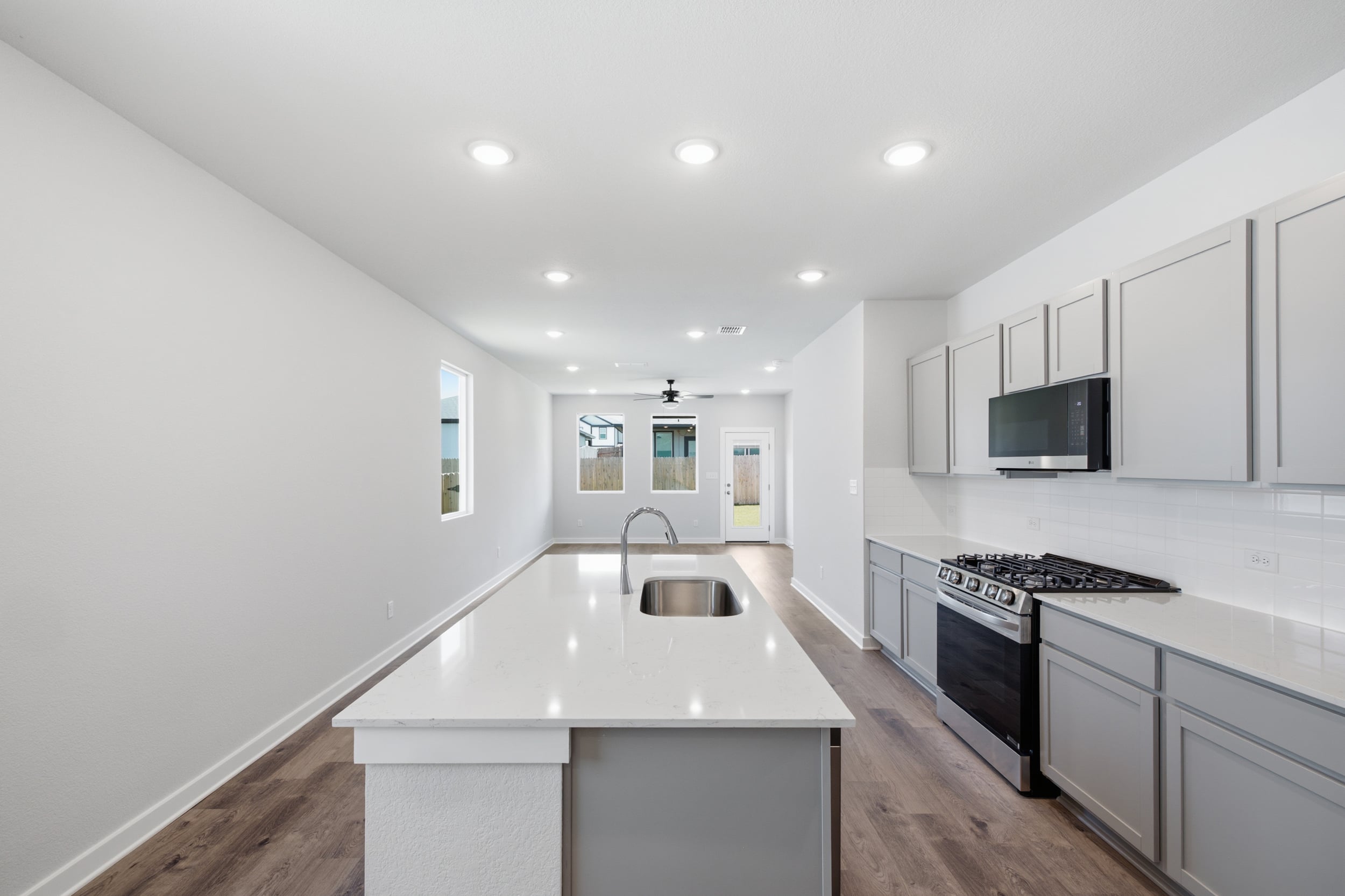 A kitchen with white cabinets.