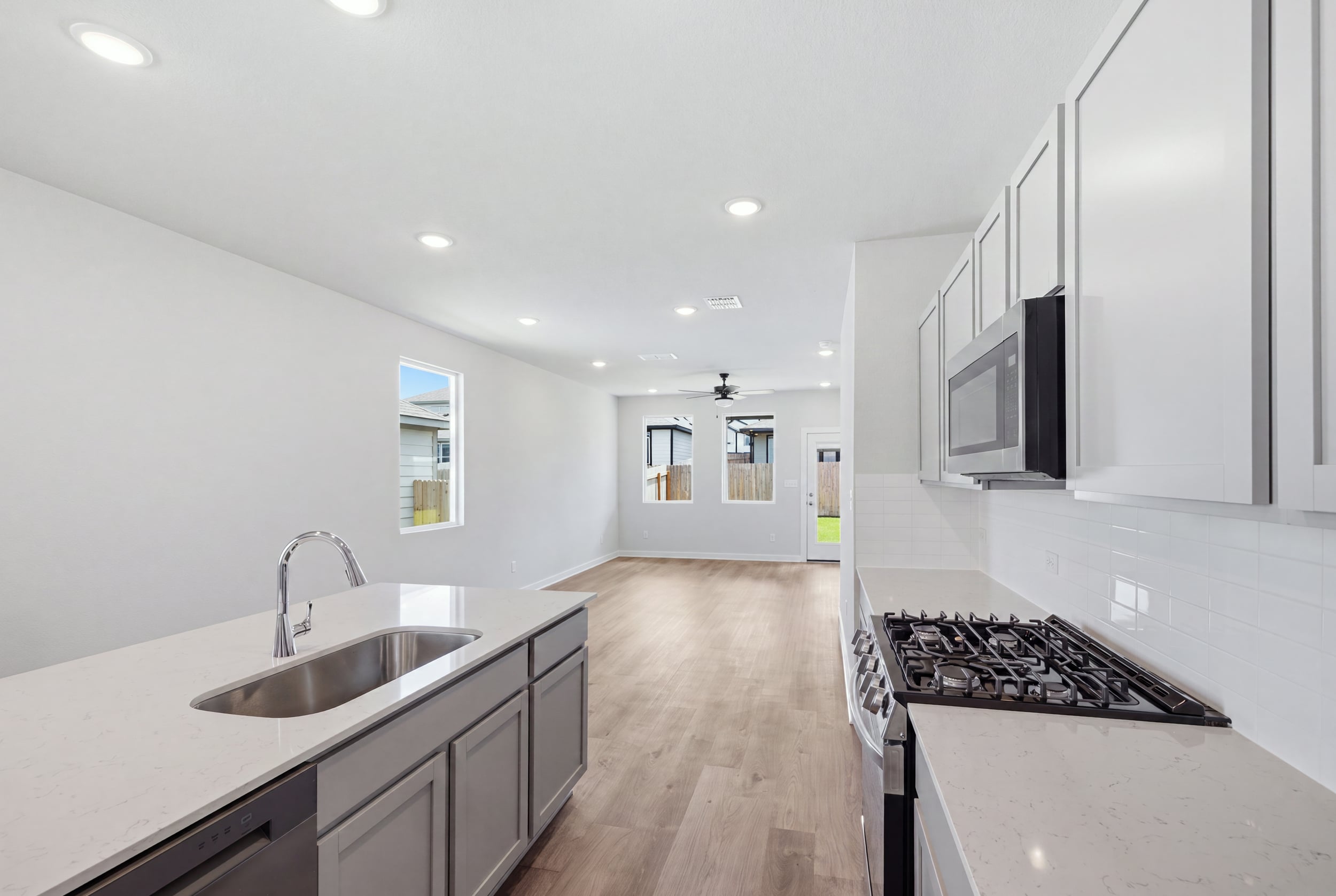 A kitchen with white cabinets.