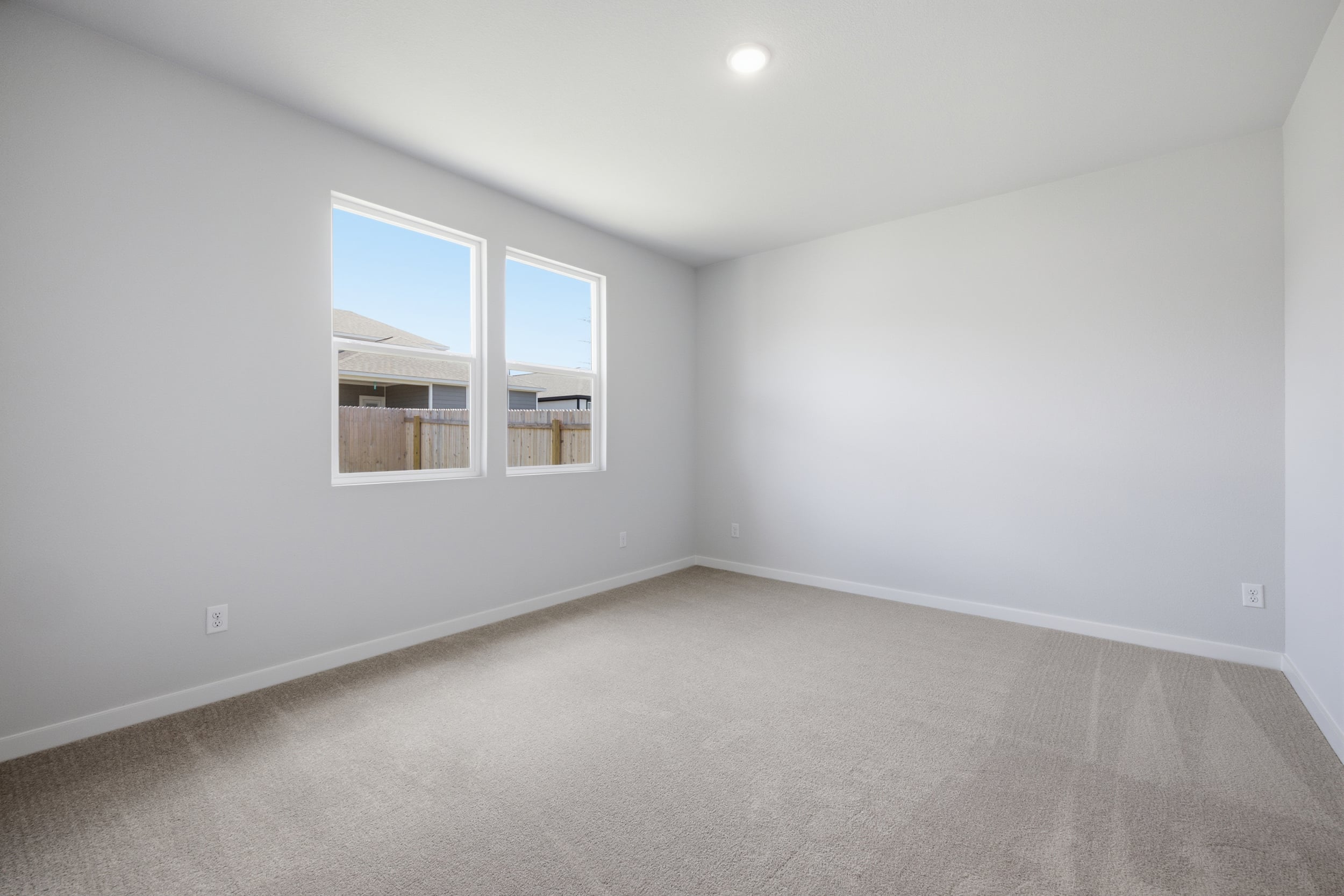 A room with a window and a carpet.