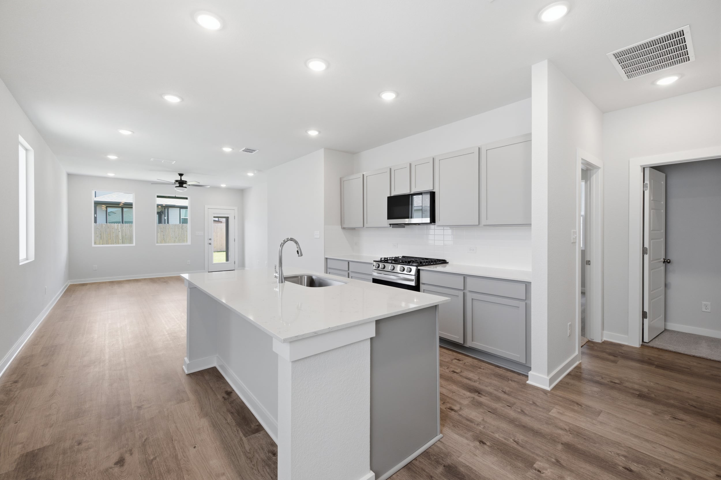 A kitchen with white cabinets.