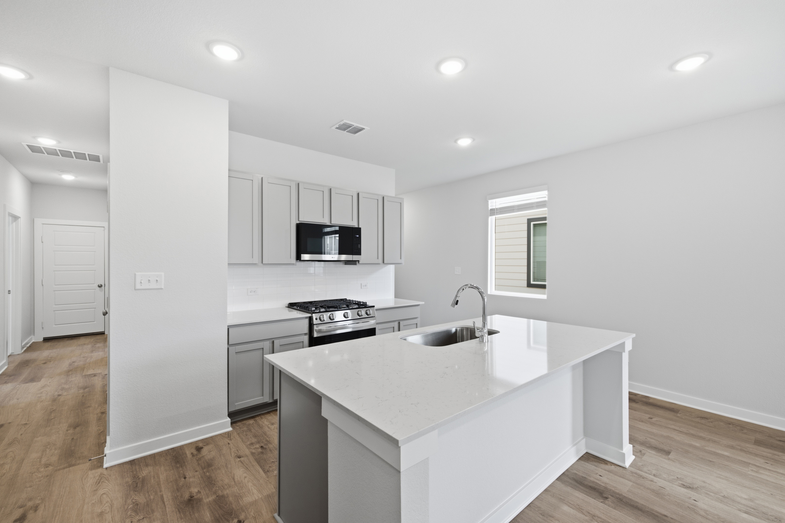 A kitchen with white cabinets.