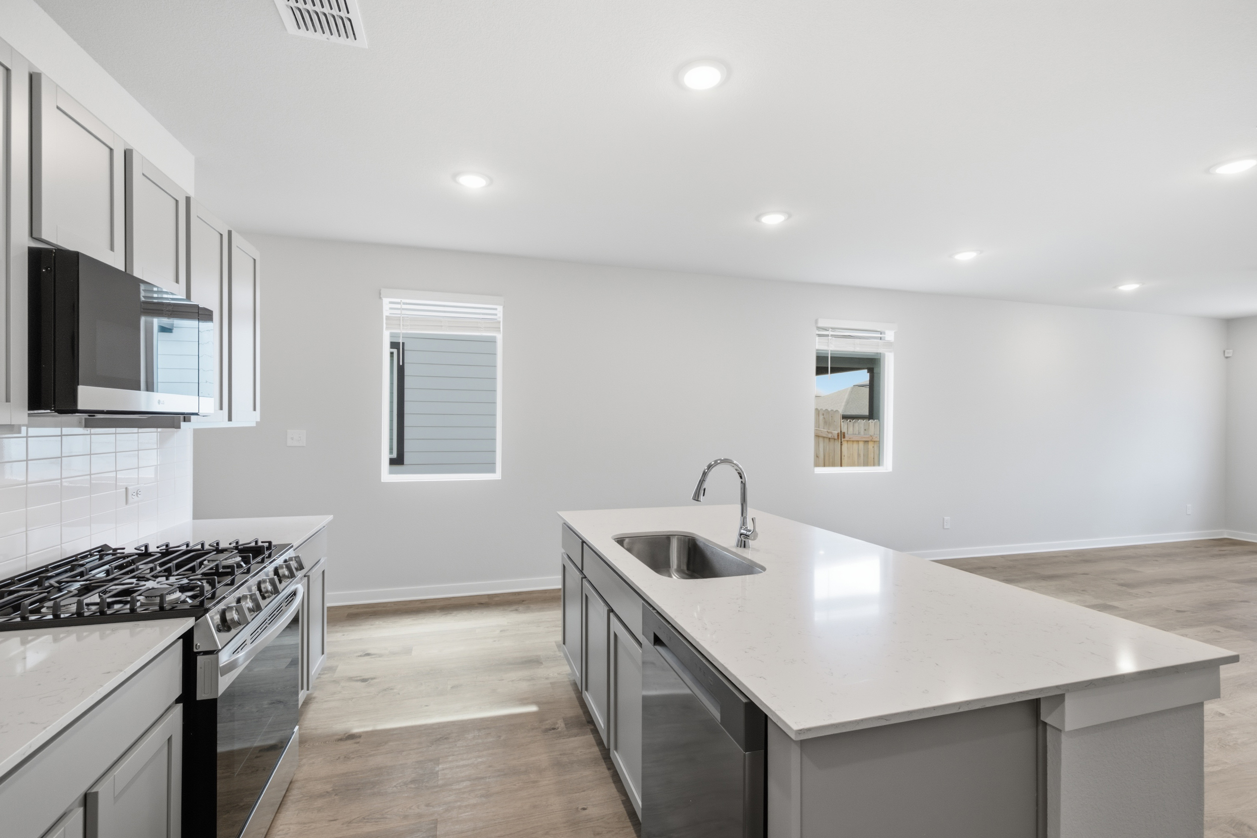 A kitchen with white tiles.