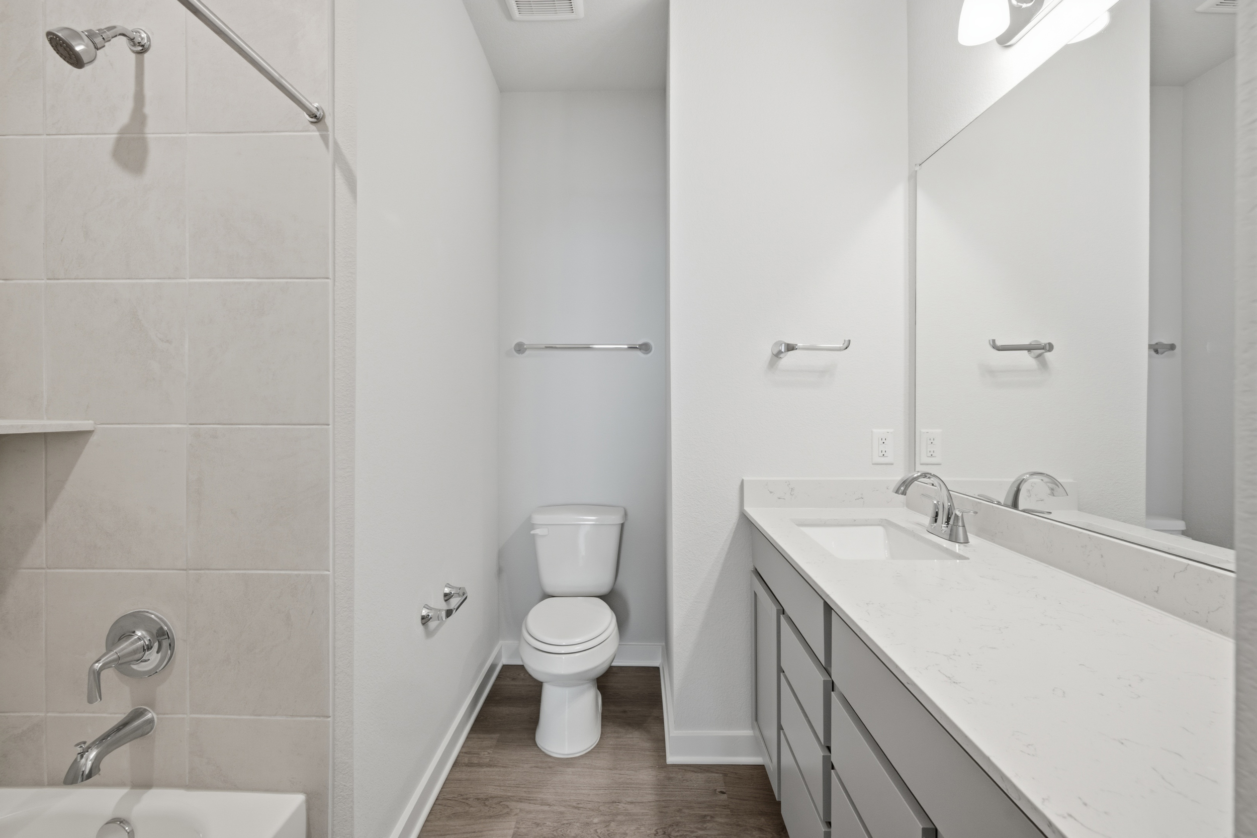 A bathroom with a toilet sink and mirror.