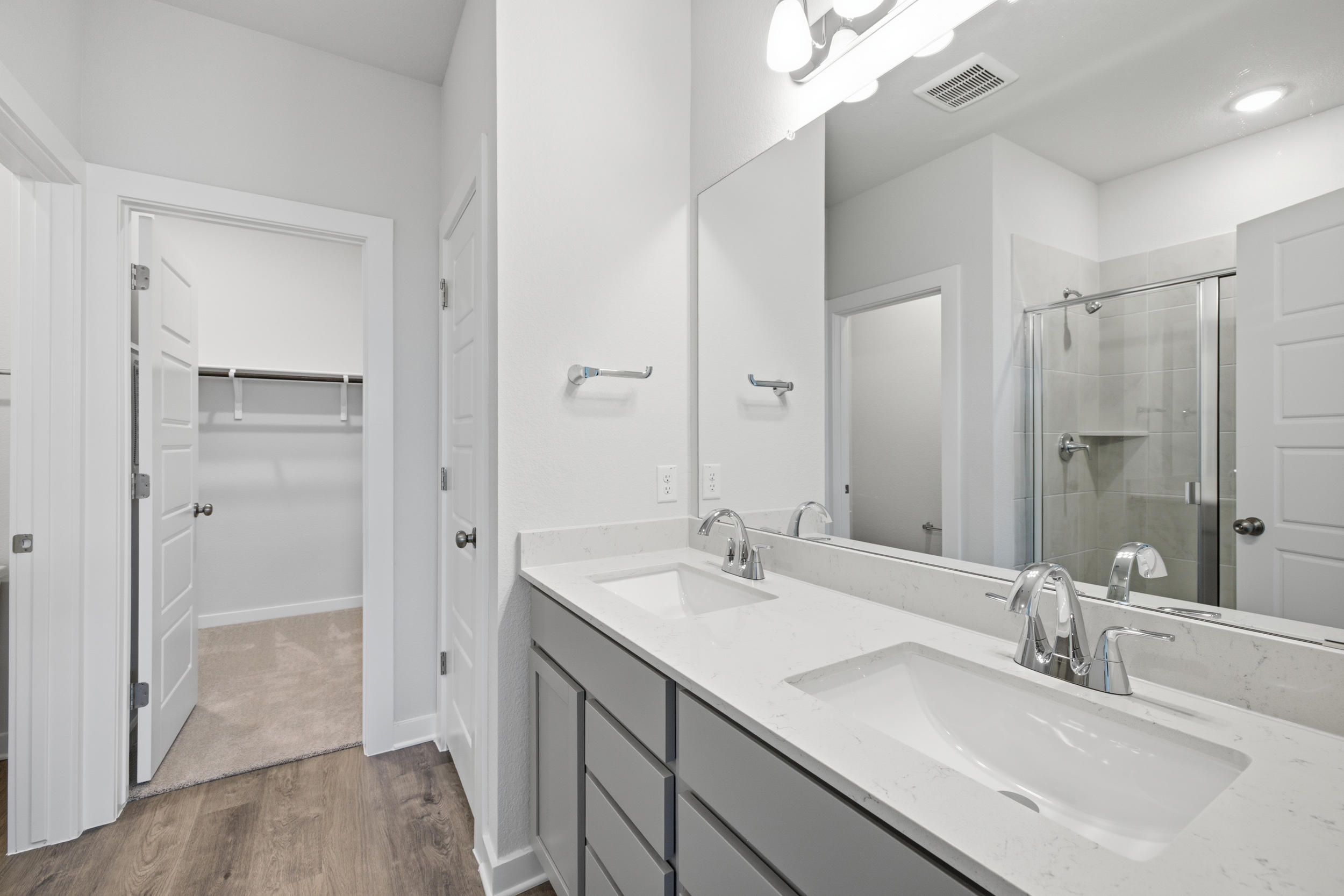 A bathroom with a large mirror.