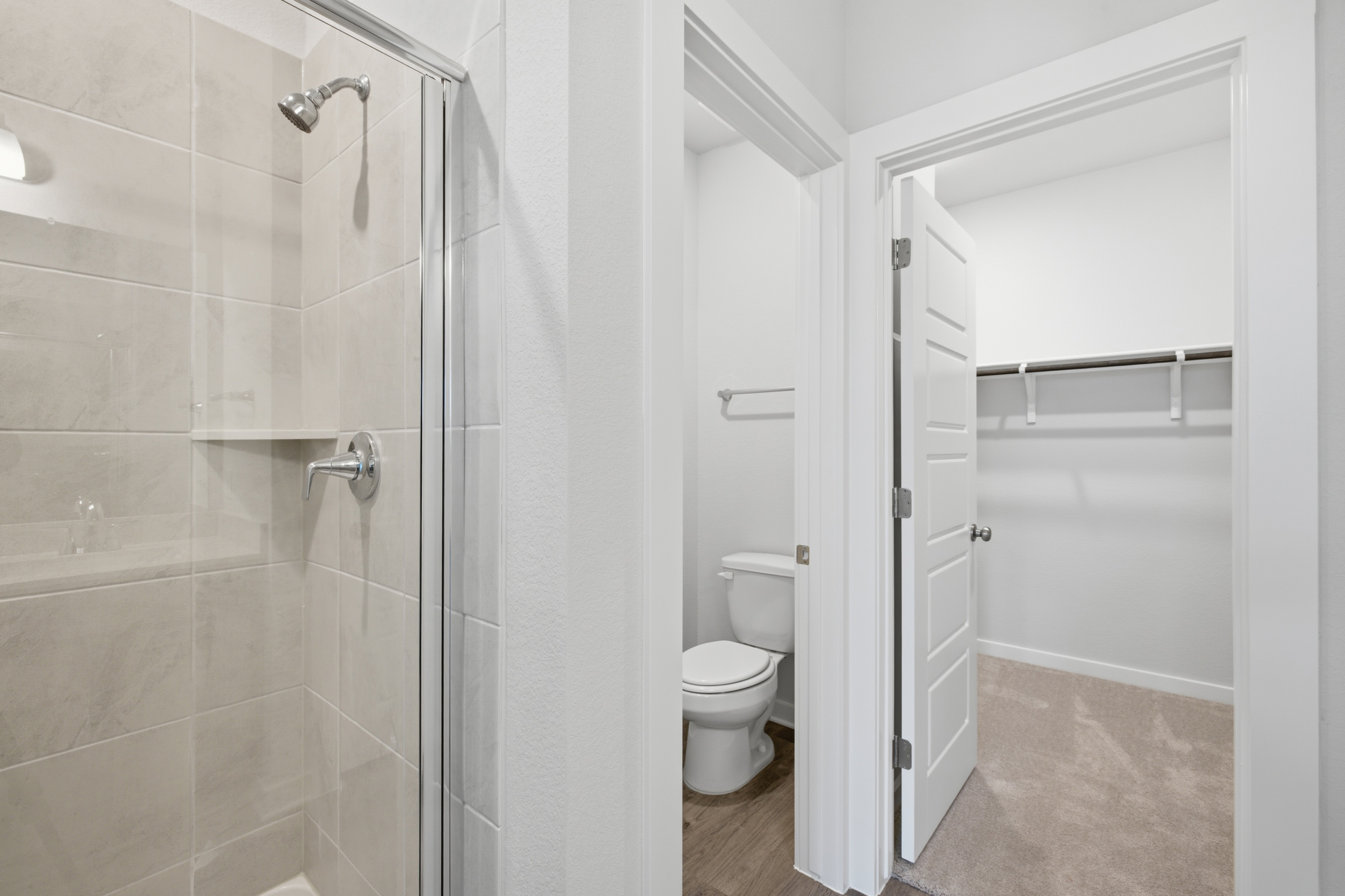 A bathroom with a toilet and shower.