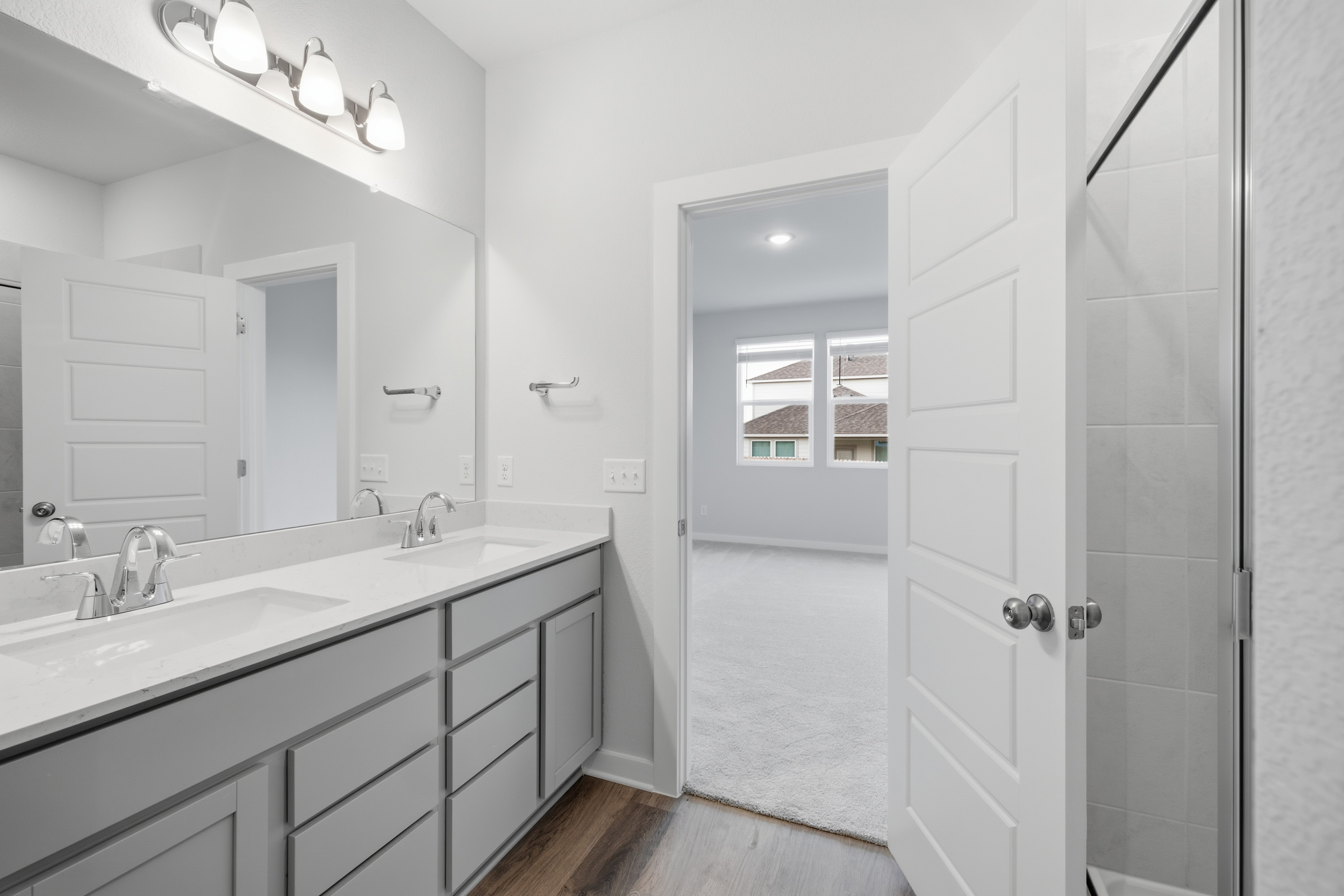 A bathroom with a sink and a shower unit.