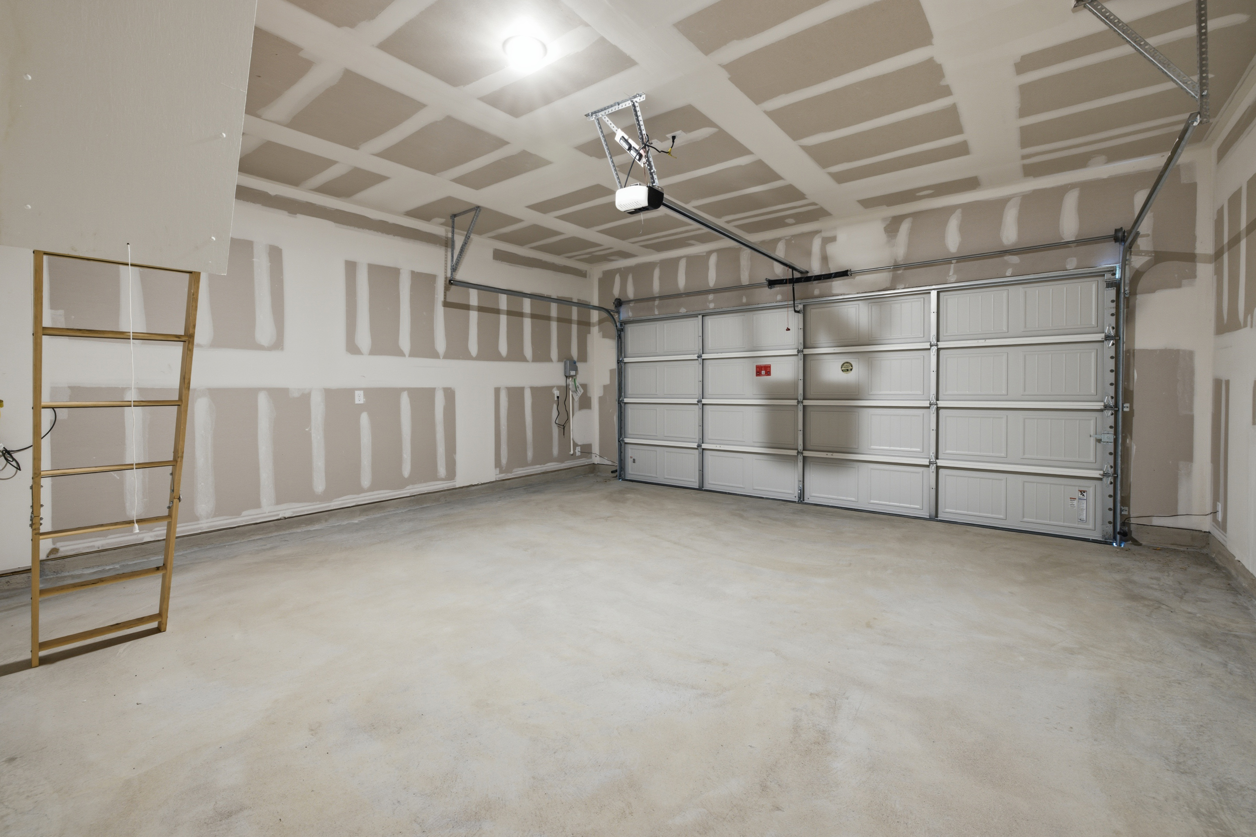 A room with a ladder and a metal box.