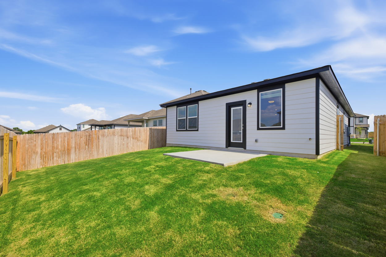 A house with a fence and grass.