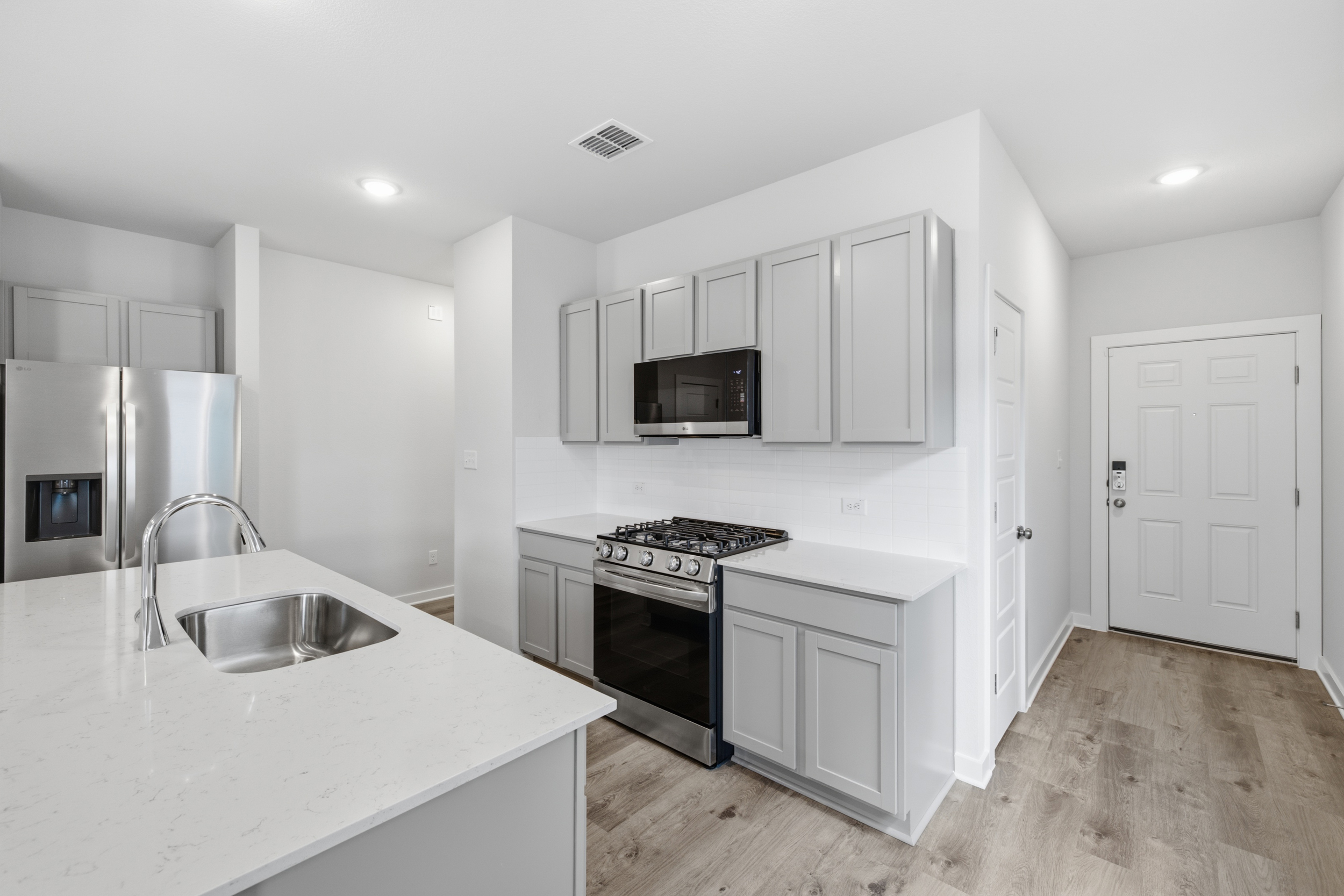 A kitchen with white cabinets.