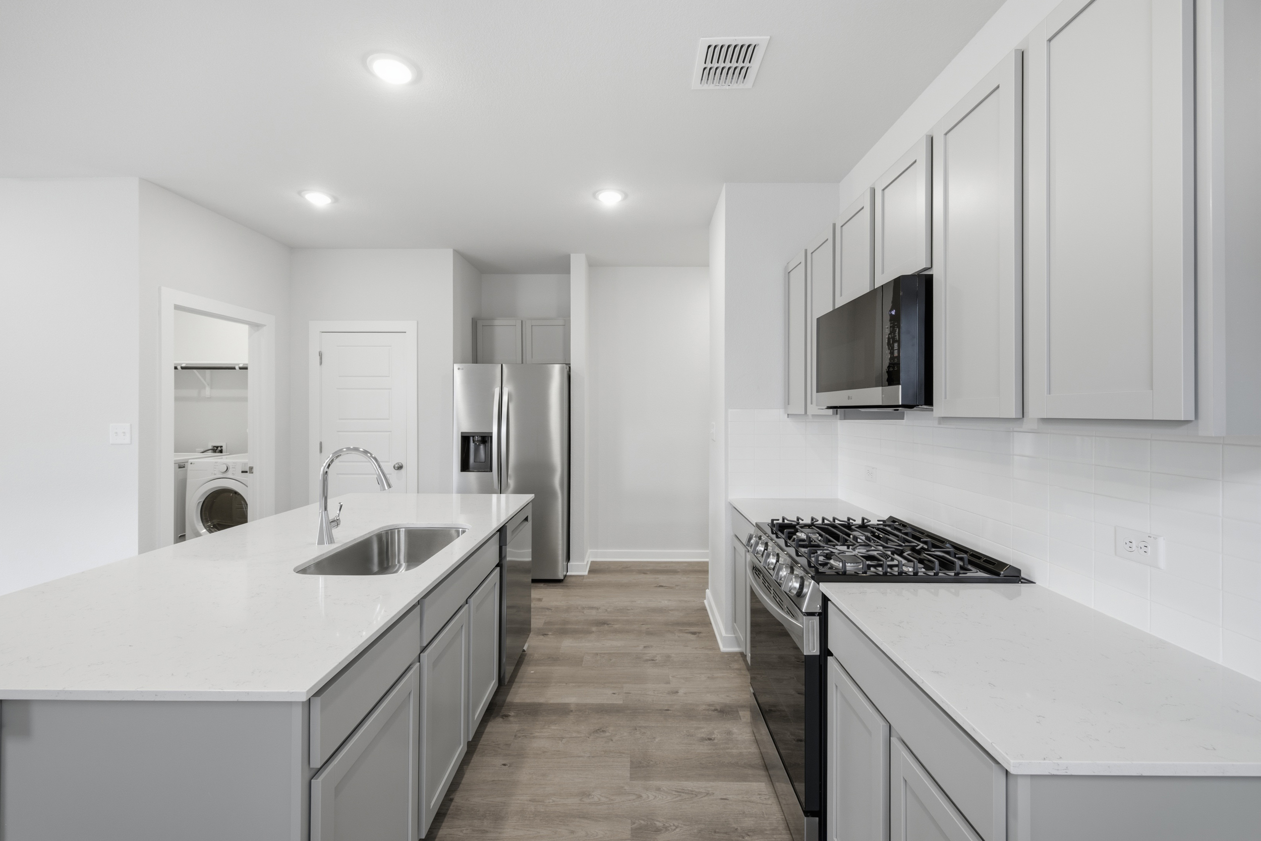 A kitchen with white cabinets.