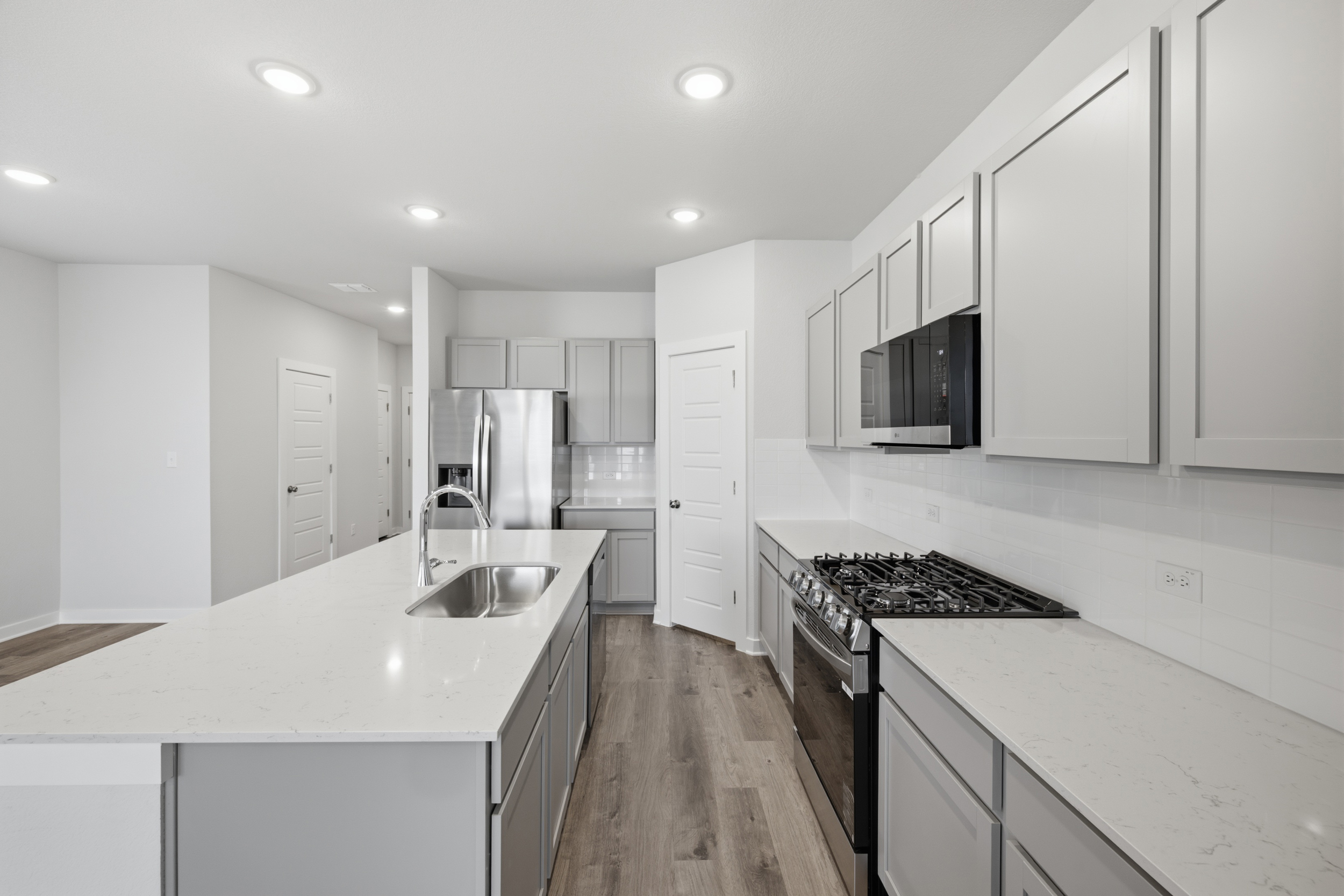 A kitchen with white cabinets.
