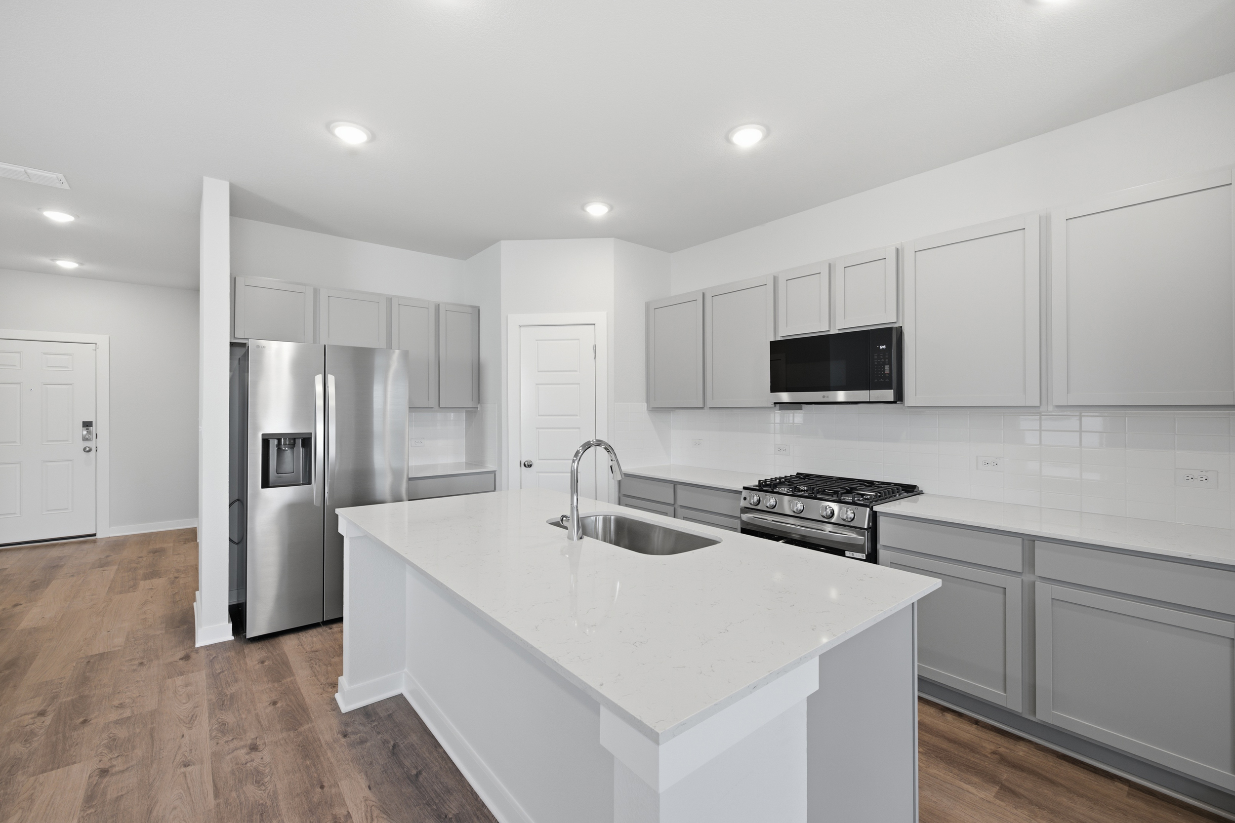 A kitchen with white cabinets.