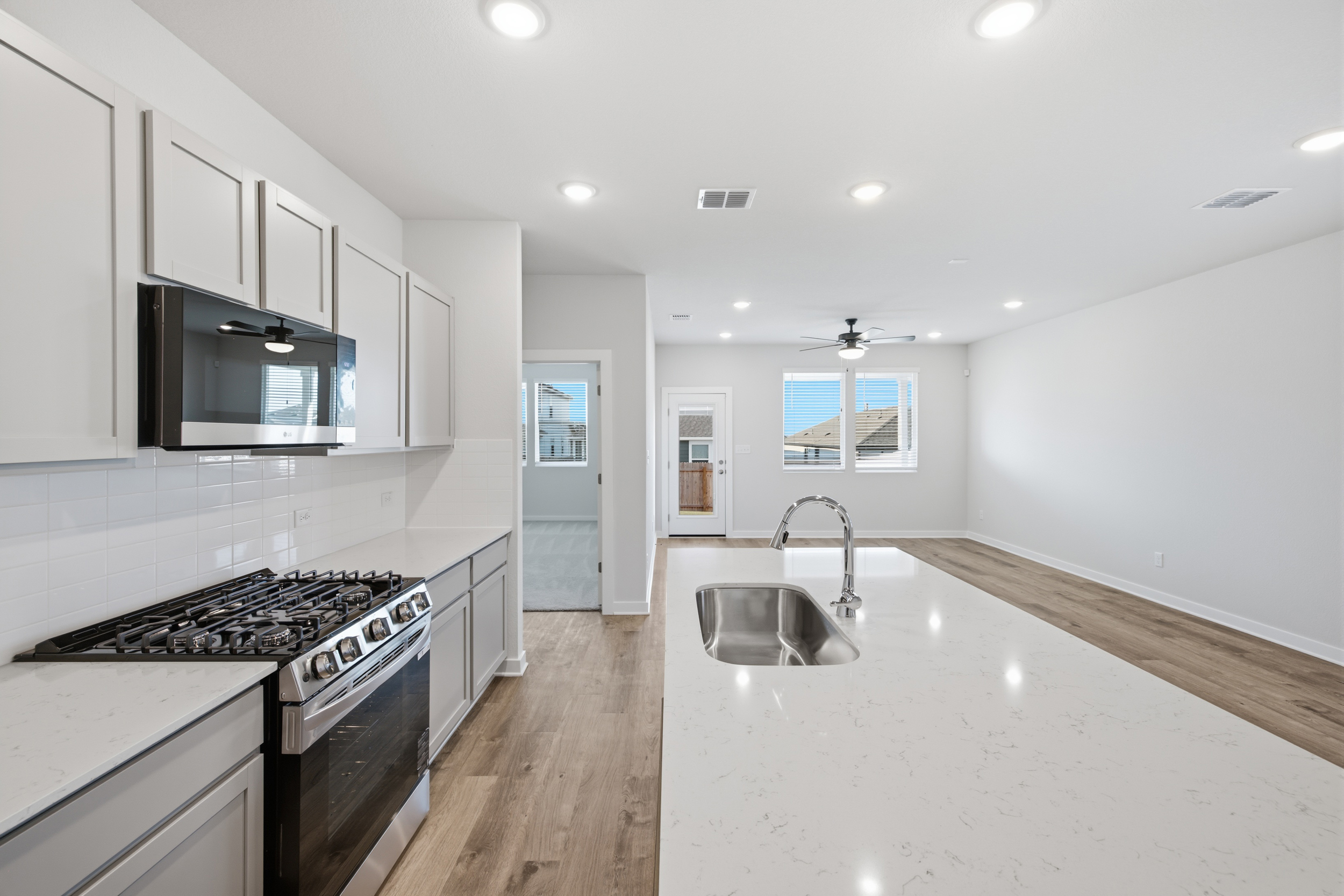 A kitchen with white cabinets.