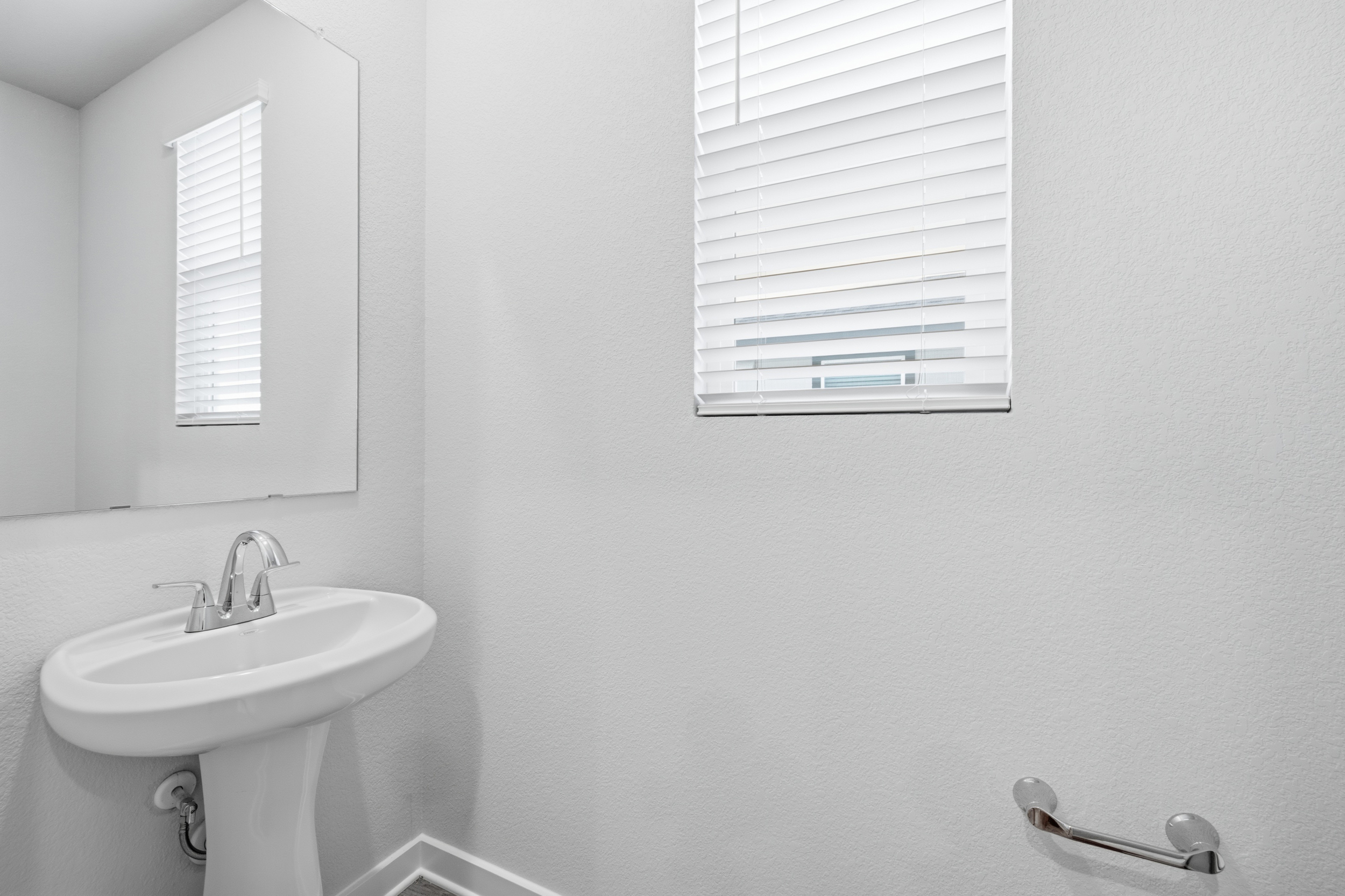 A bathroom with a sink and a mirror.
