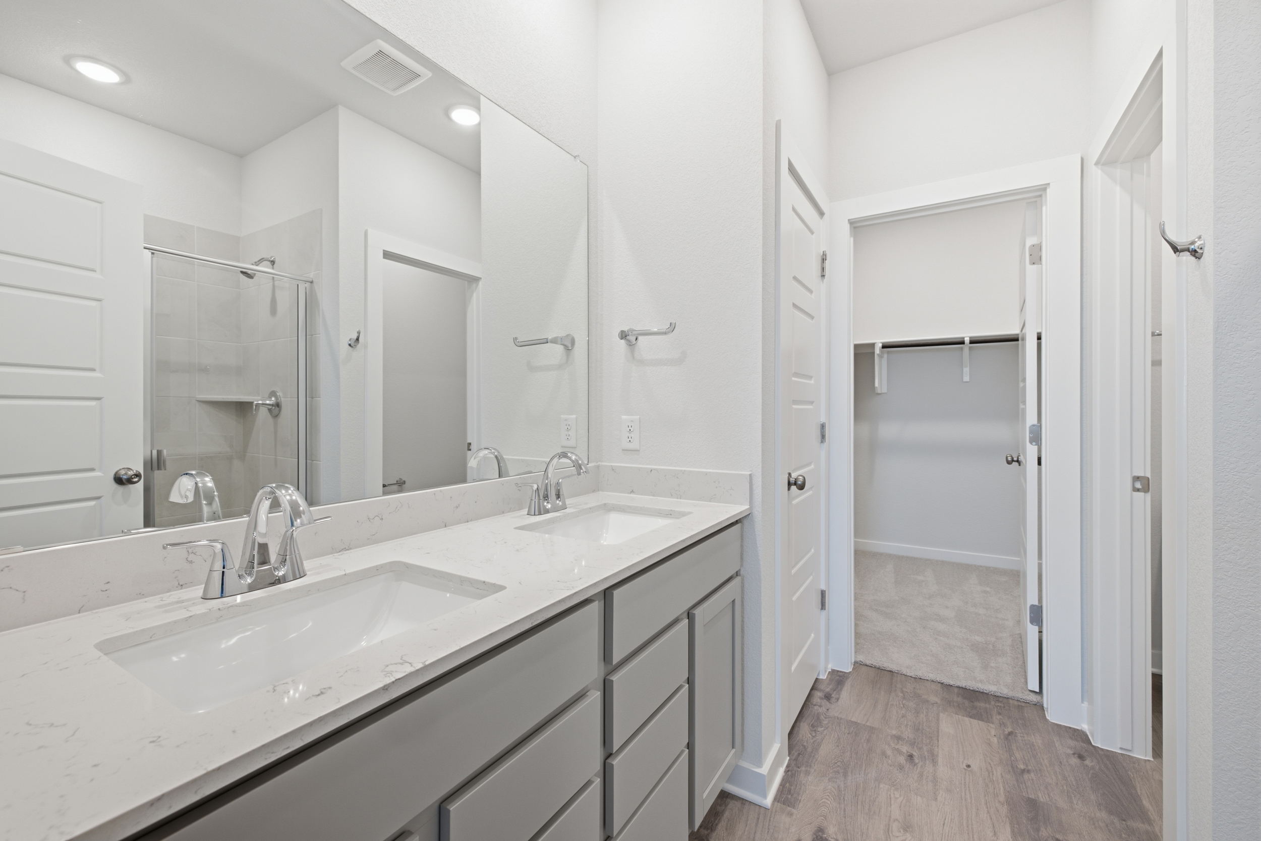 A bathroom with a large mirror.