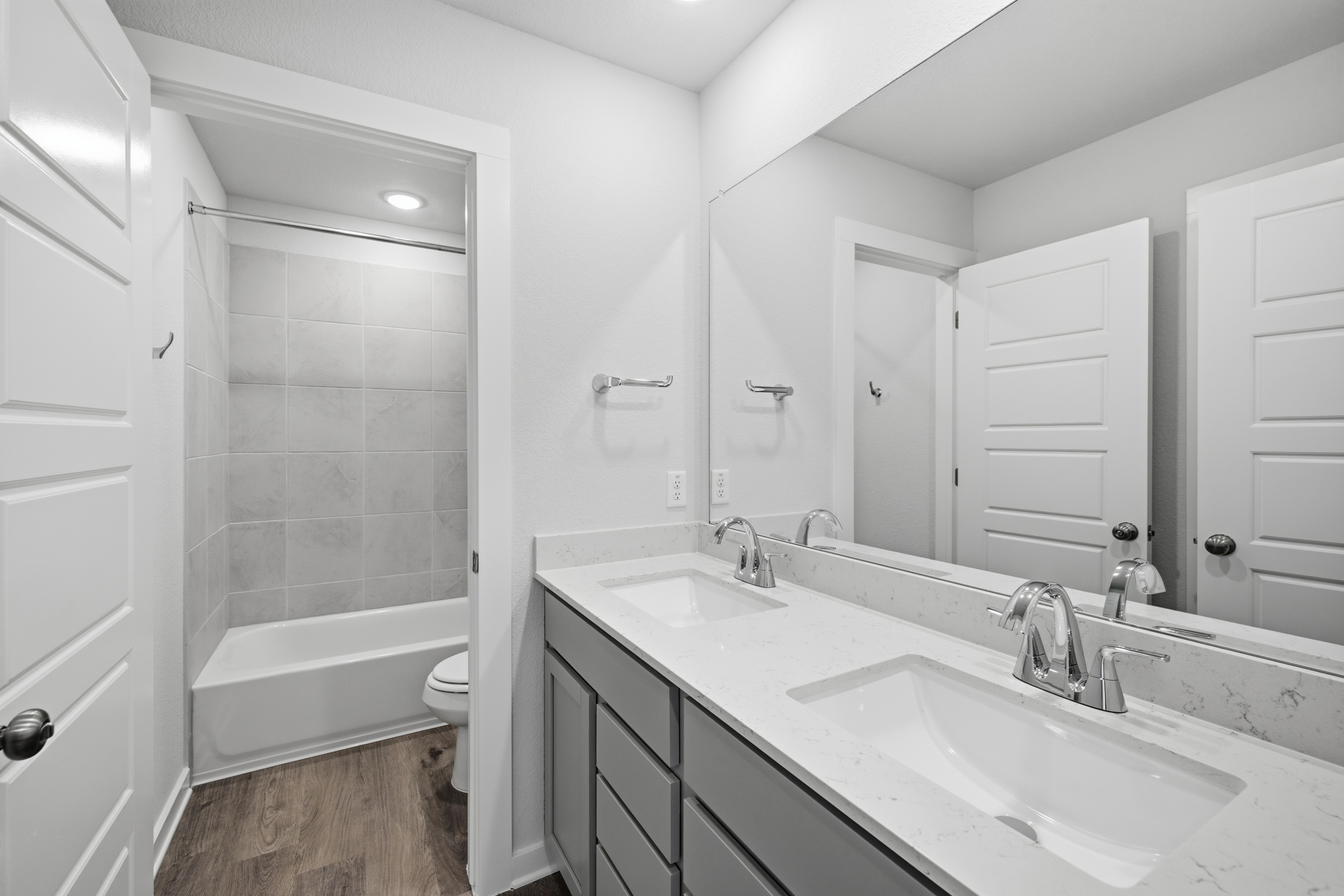 A bathroom with a tub sink and toilet.