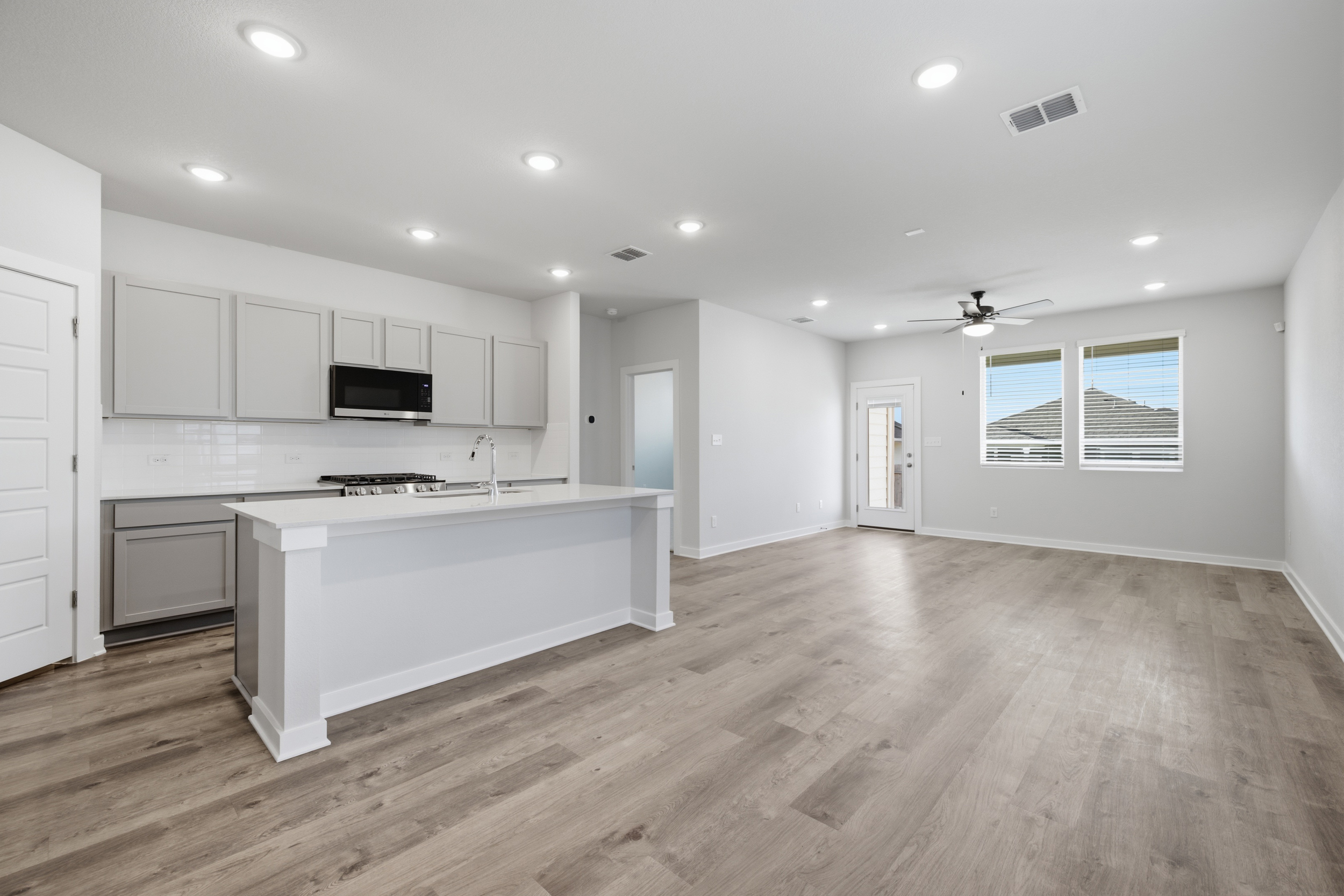 A kitchen with white cabinets.