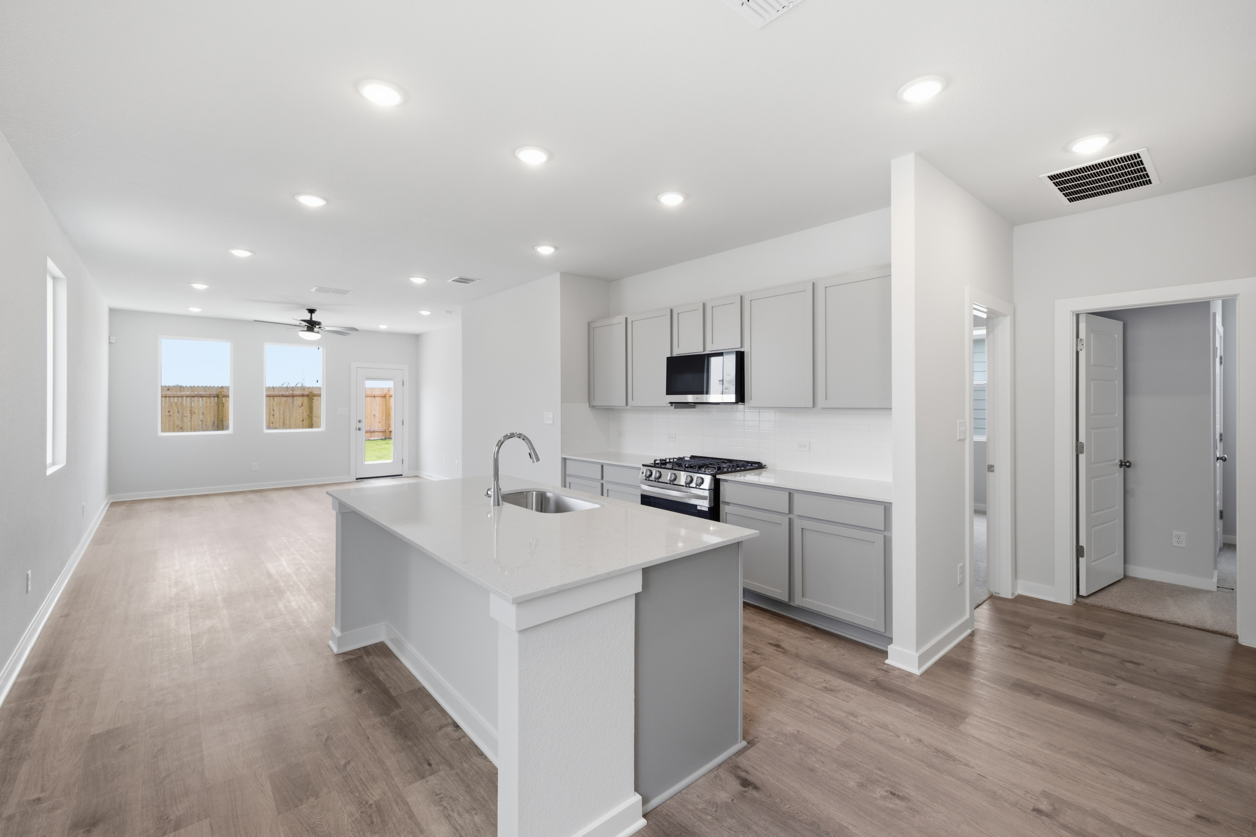 A kitchen with white cabinets.