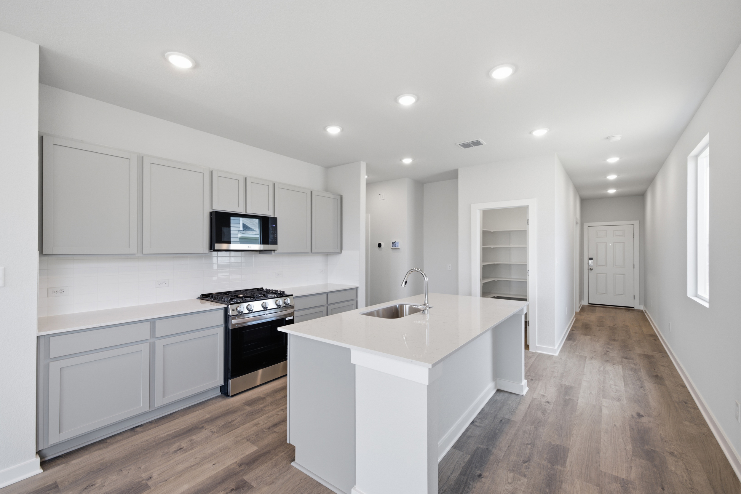 A kitchen with white cabinets.