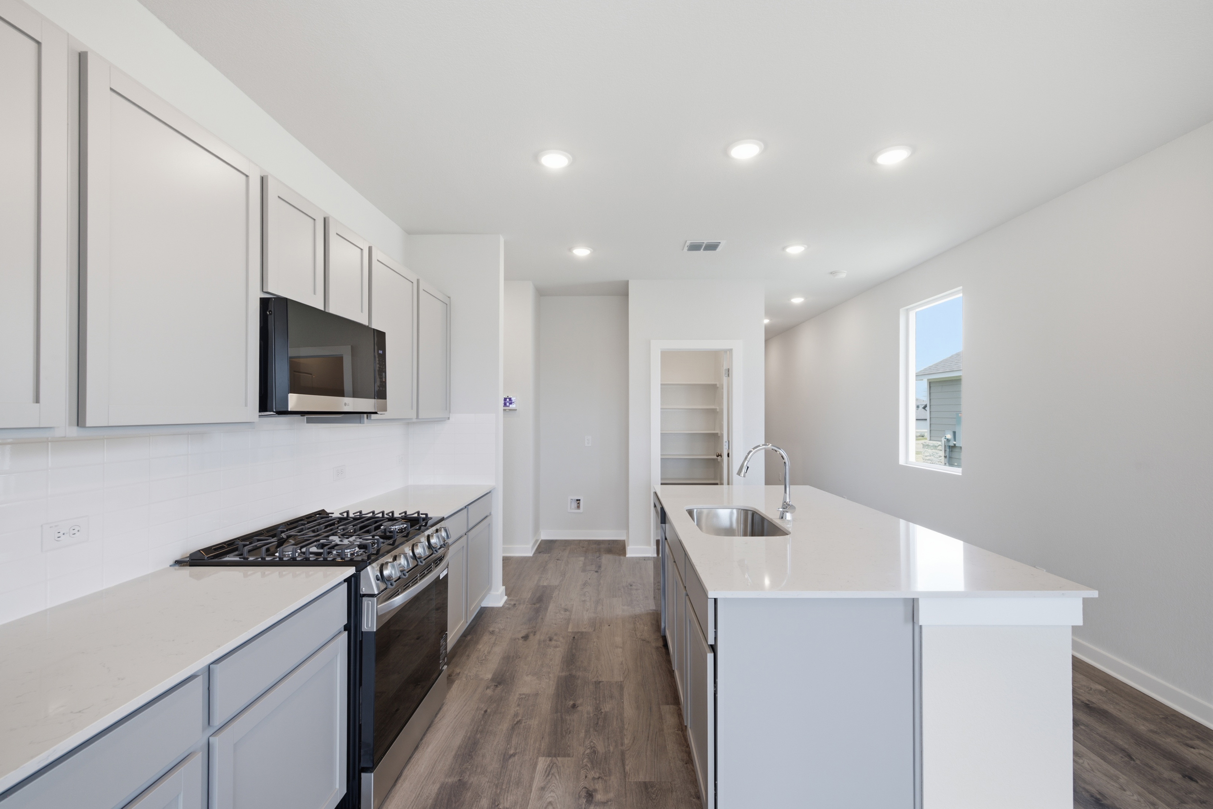 A kitchen with white cabinets.