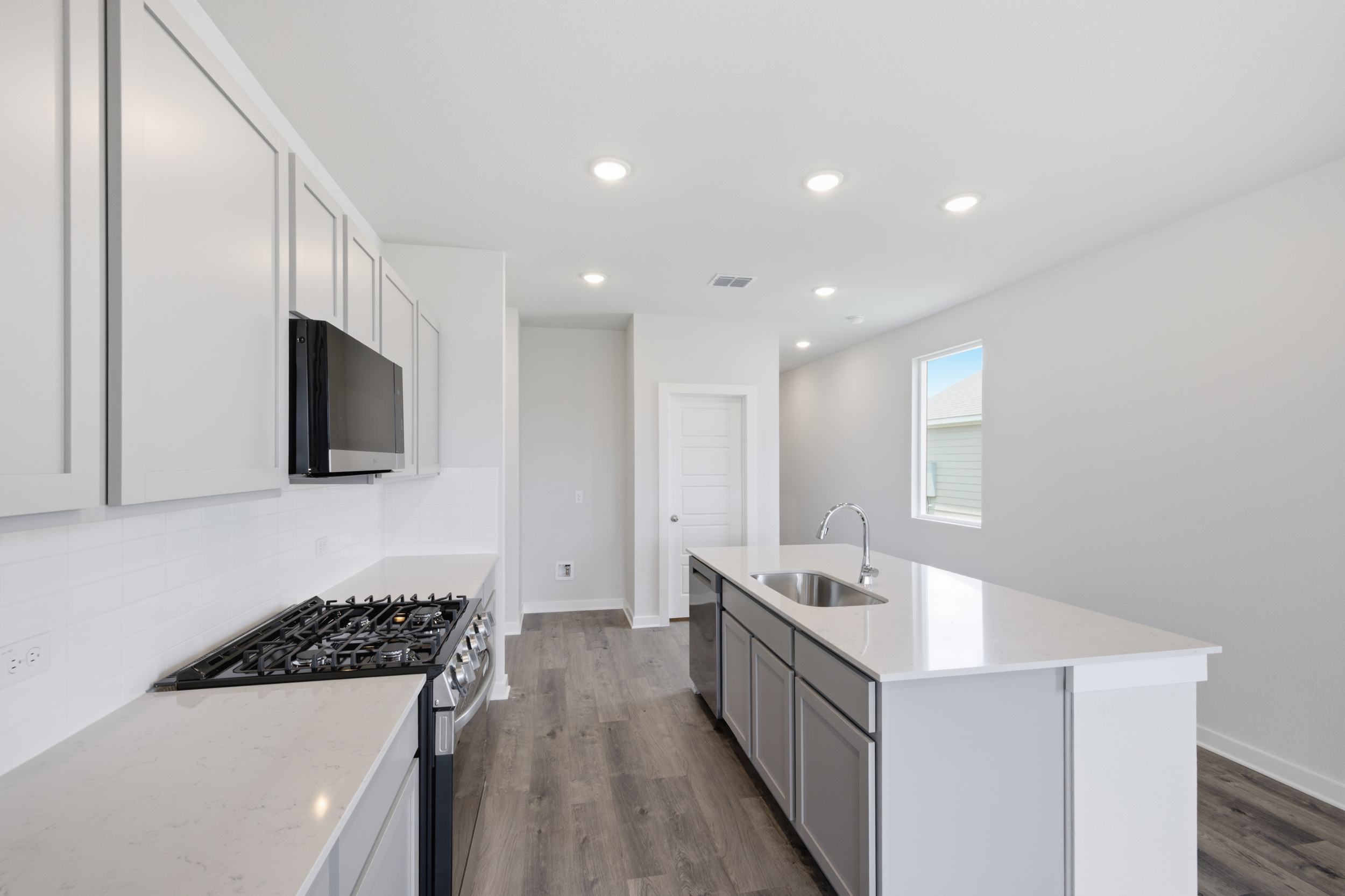 A kitchen with white cabinets.
