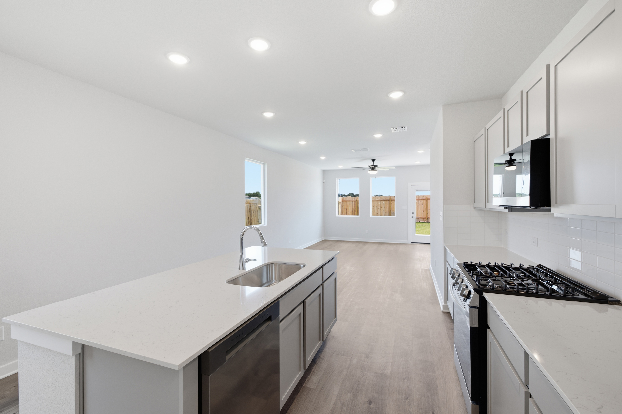 A kitchen with white cabinets.