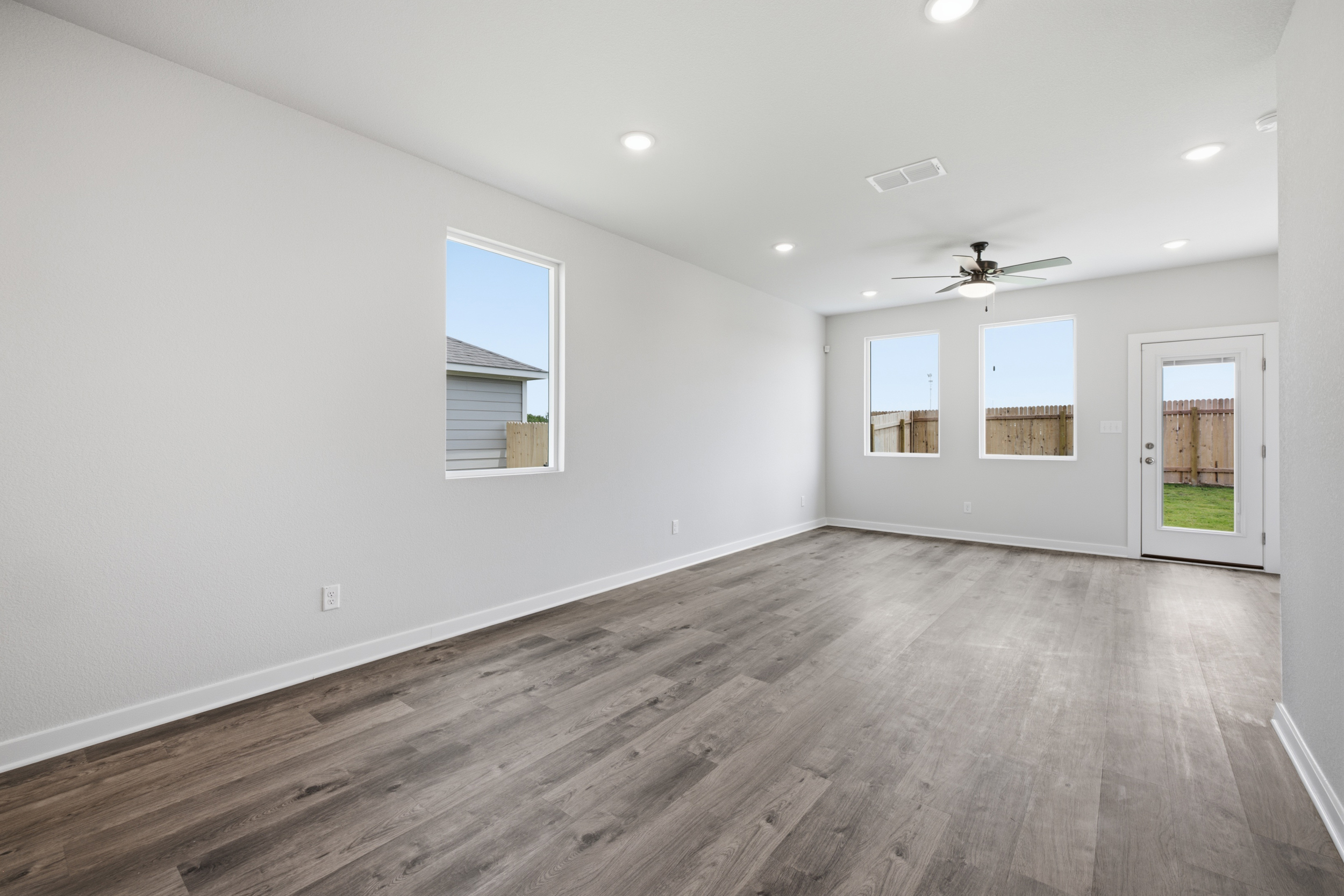 A room with a wood floor and white walls.