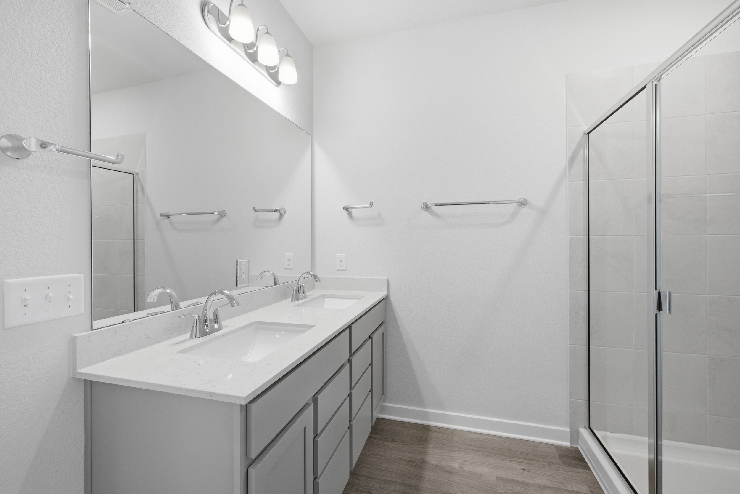 A bathroom with a sink and shower.
