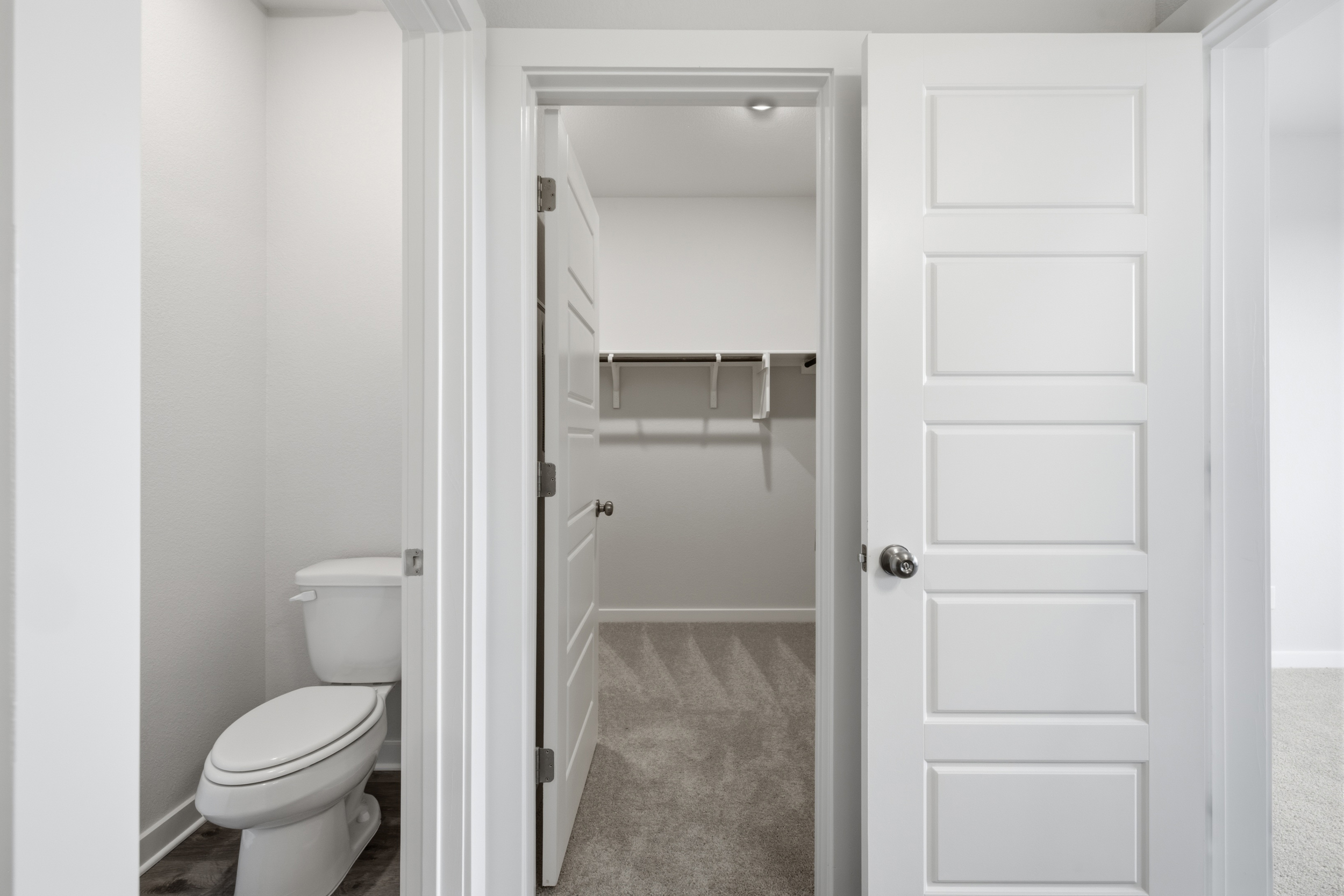 A bathroom with a toilet and shower.