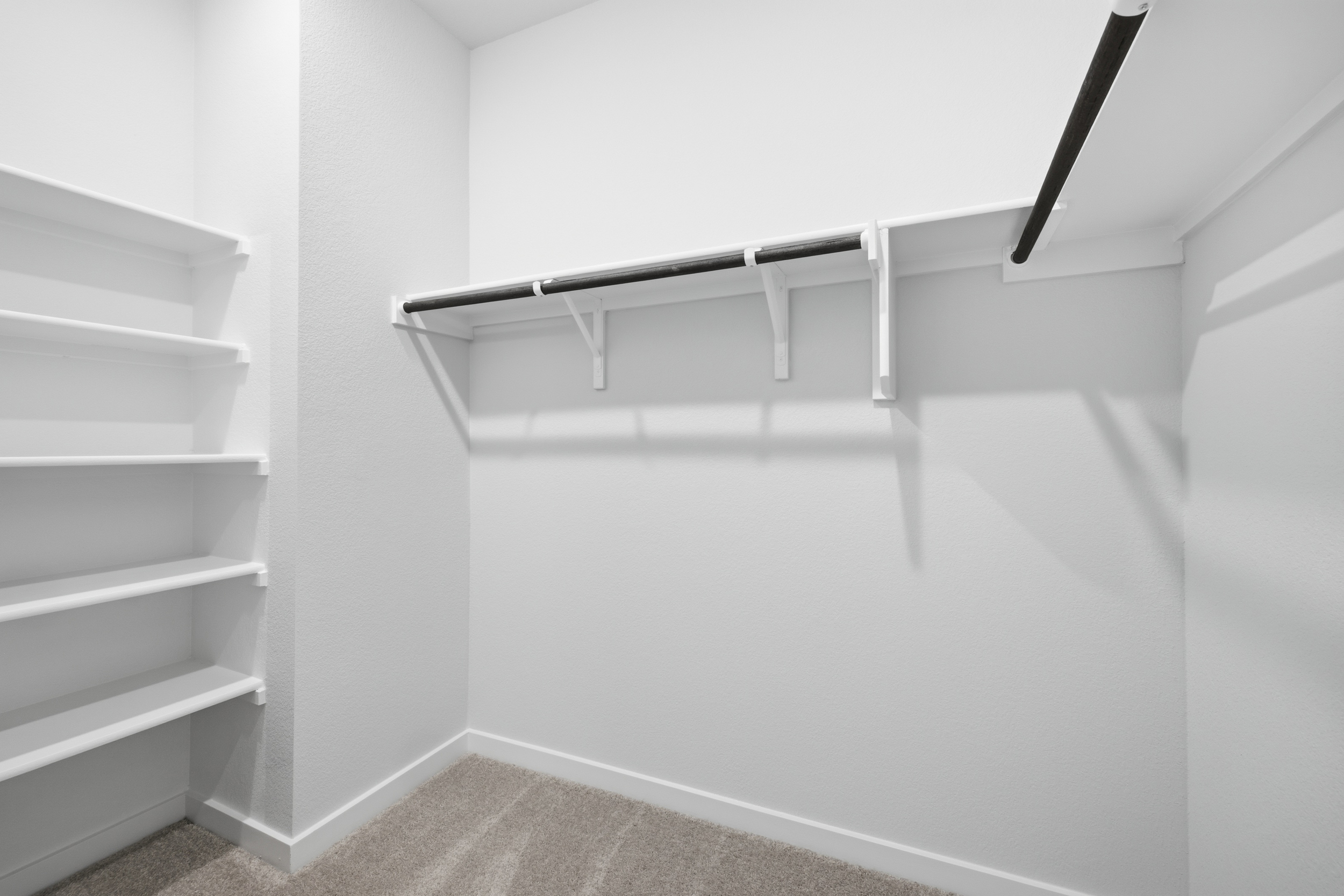 A white staircase with a black railing.