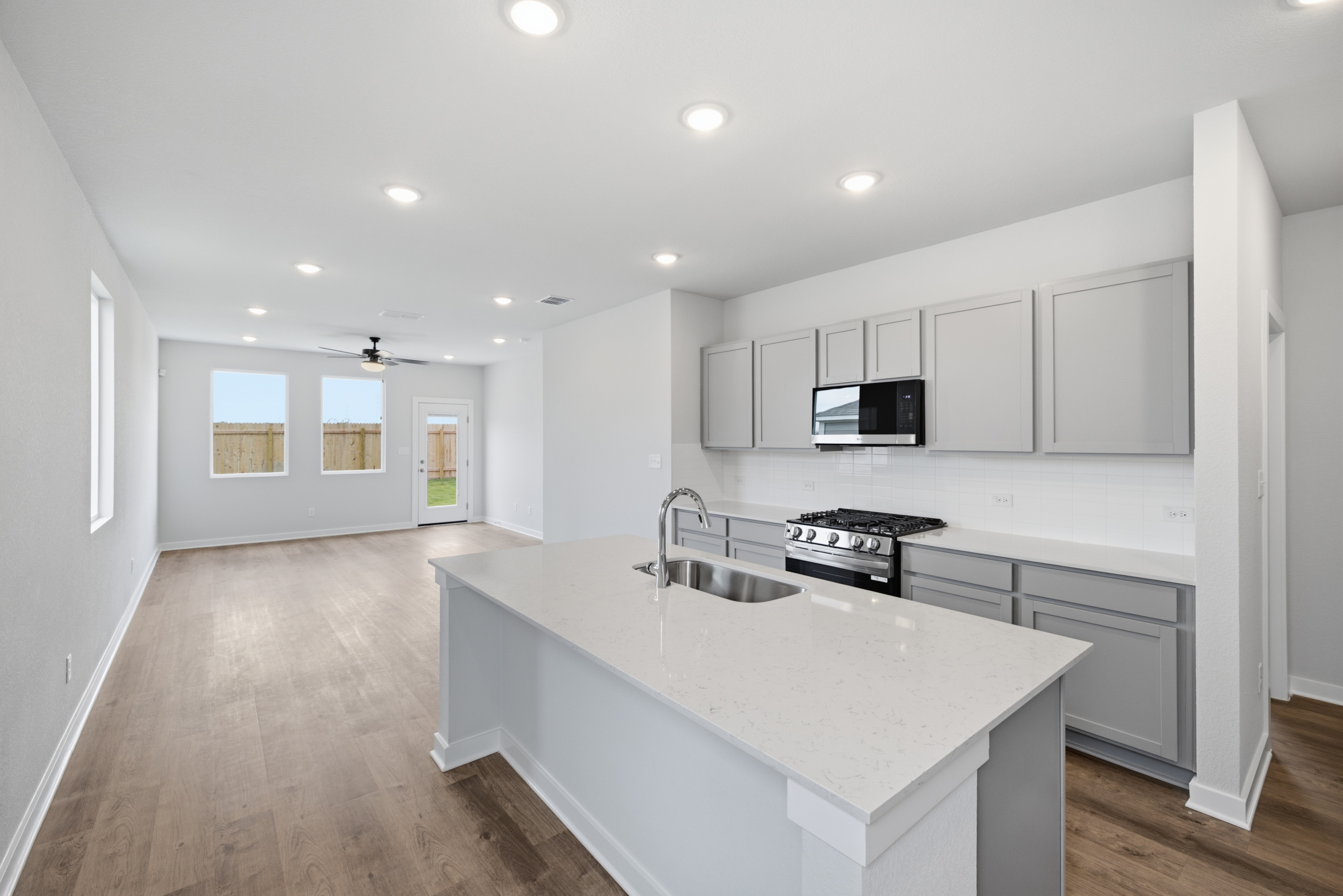 A kitchen with white cabinets.