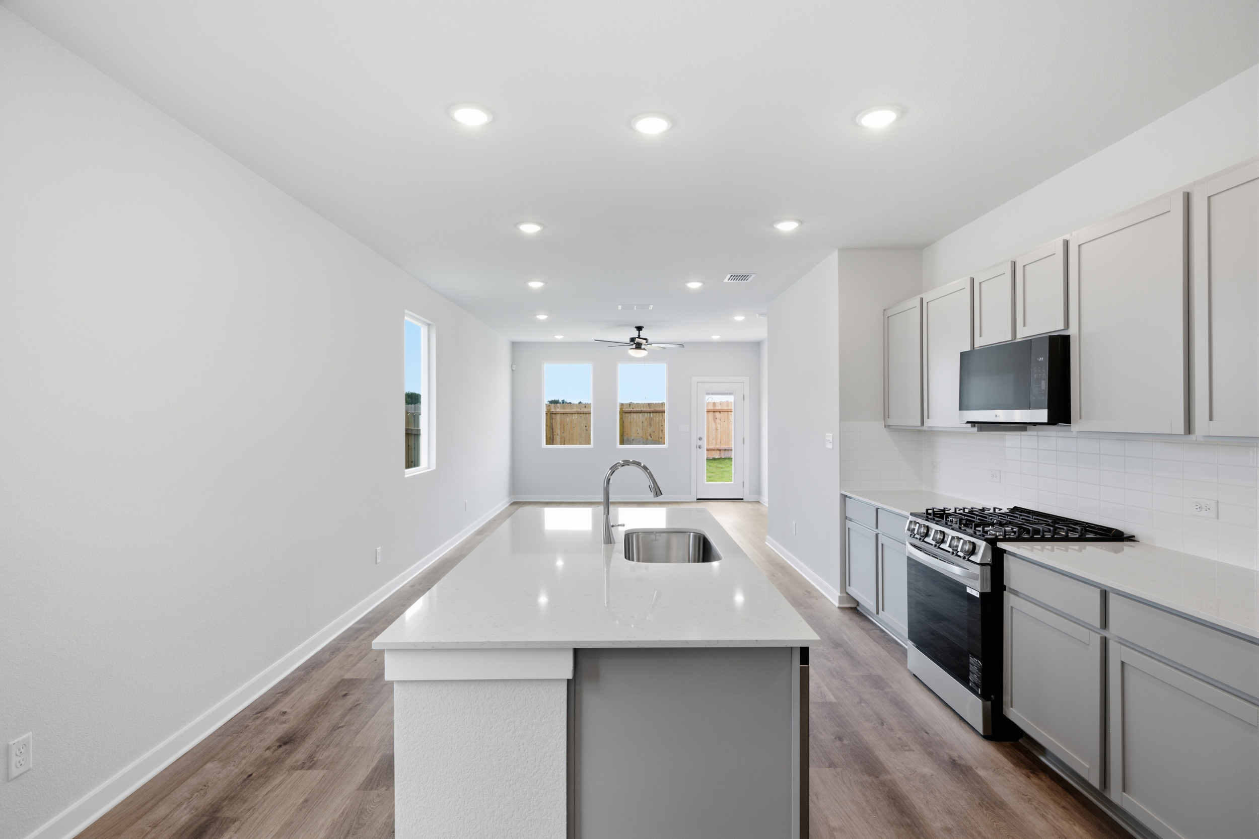A kitchen with white cabinets.