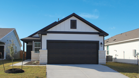 A house with a garage with American Gothic House in the background.