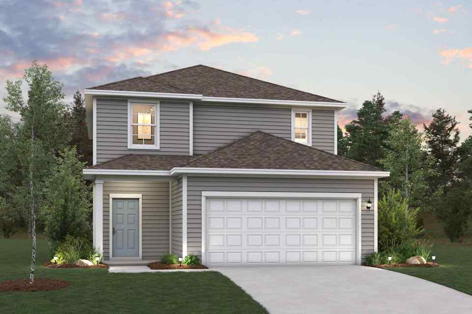 A house with a garage and trees around it.
