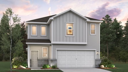 A house with a garage and trees around it.