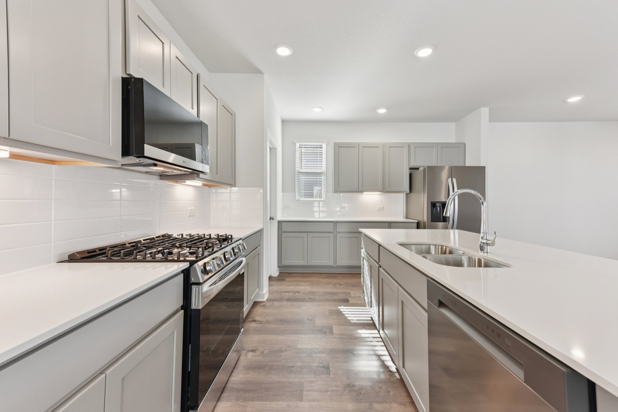 A kitchen with white cabinets.