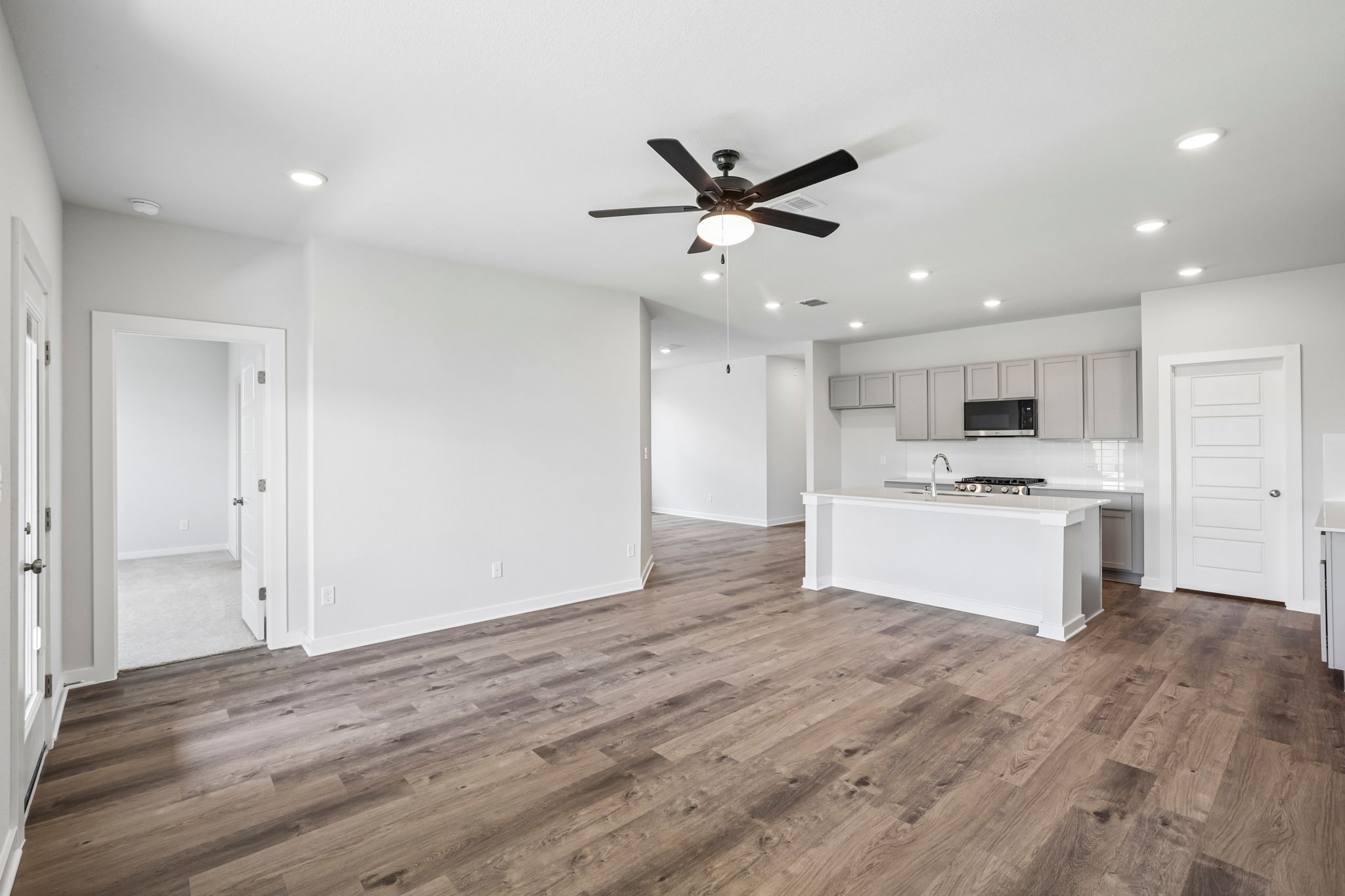 A kitchen with a wood floor.