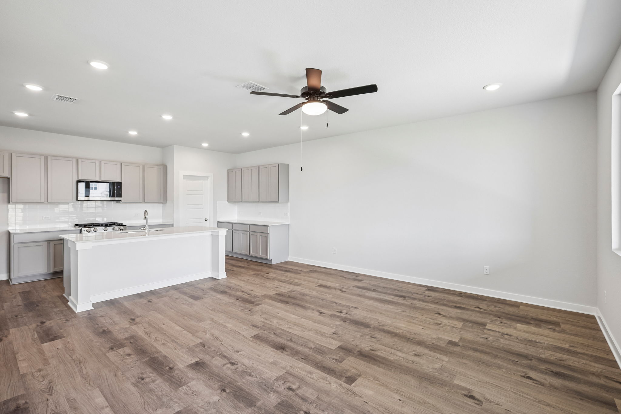 A kitchen with a wood floor.