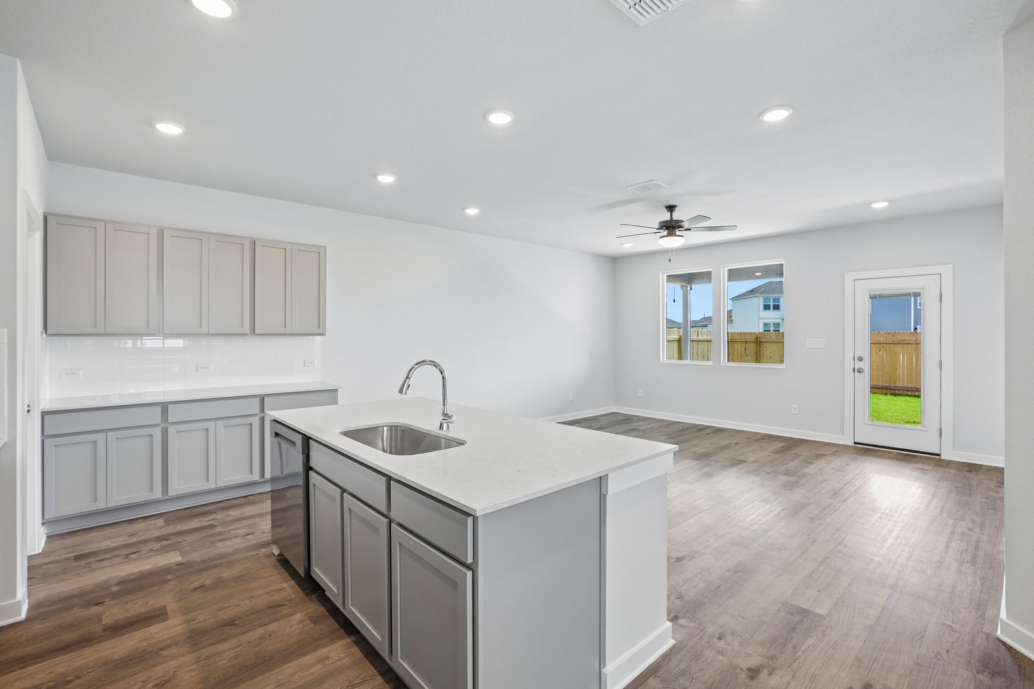 A kitchen with white cabinets.