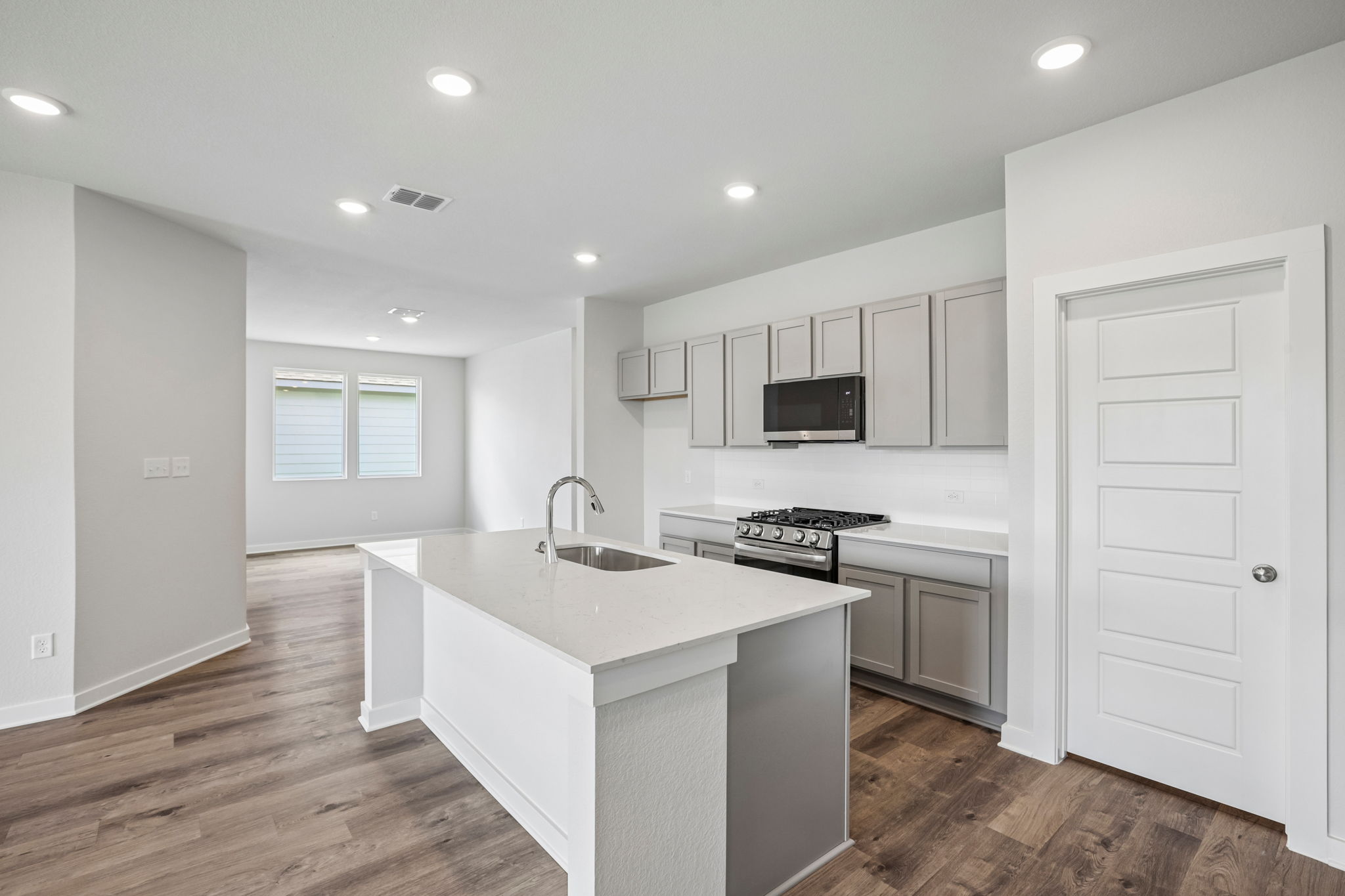 A kitchen with white cabinets.