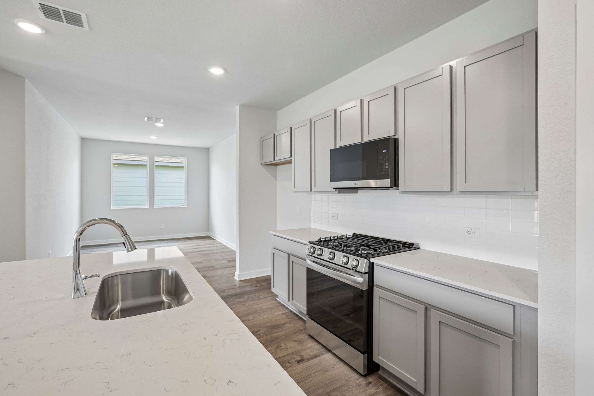 A kitchen with white cabinets.