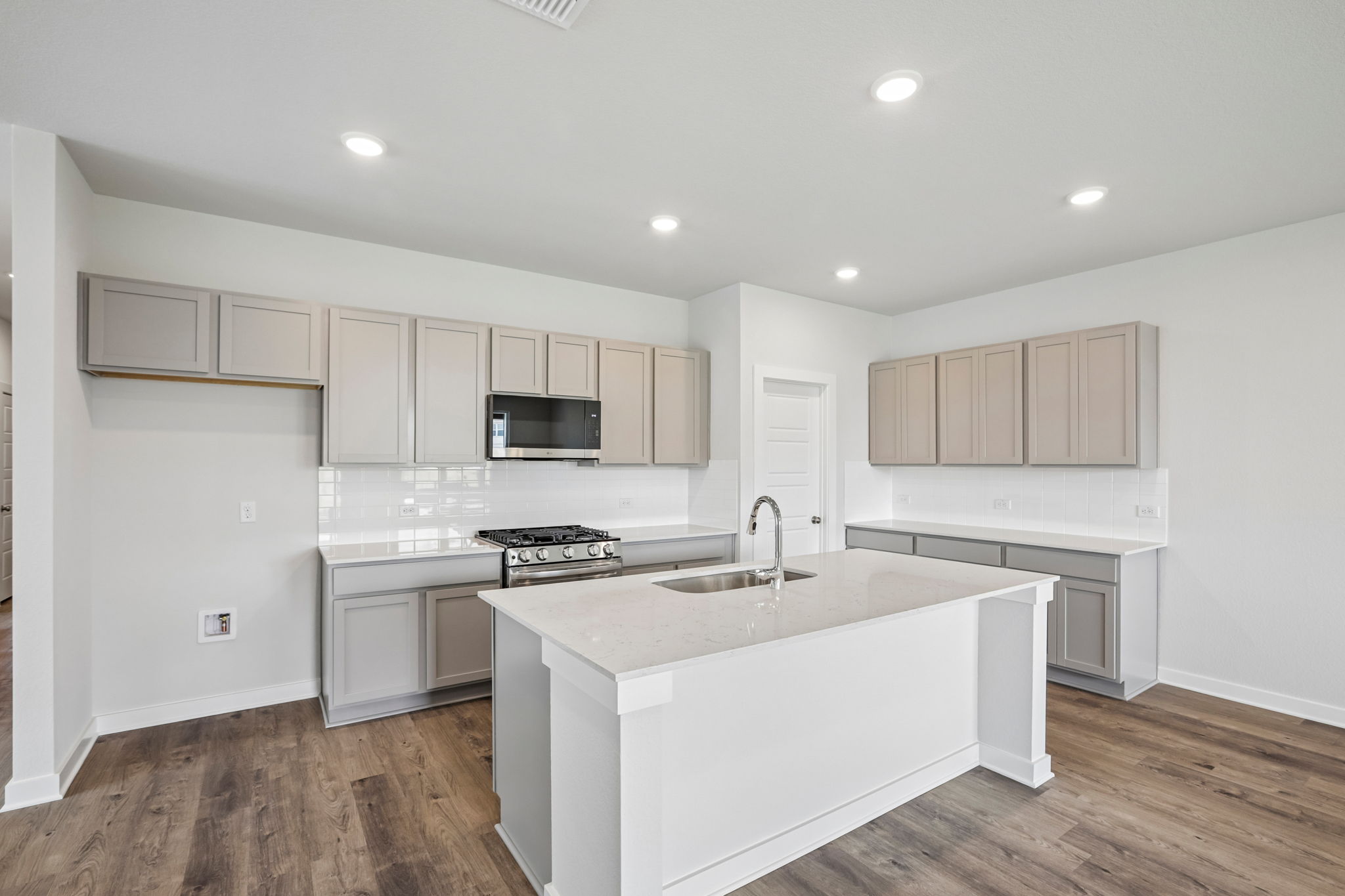 A kitchen with white cabinets.